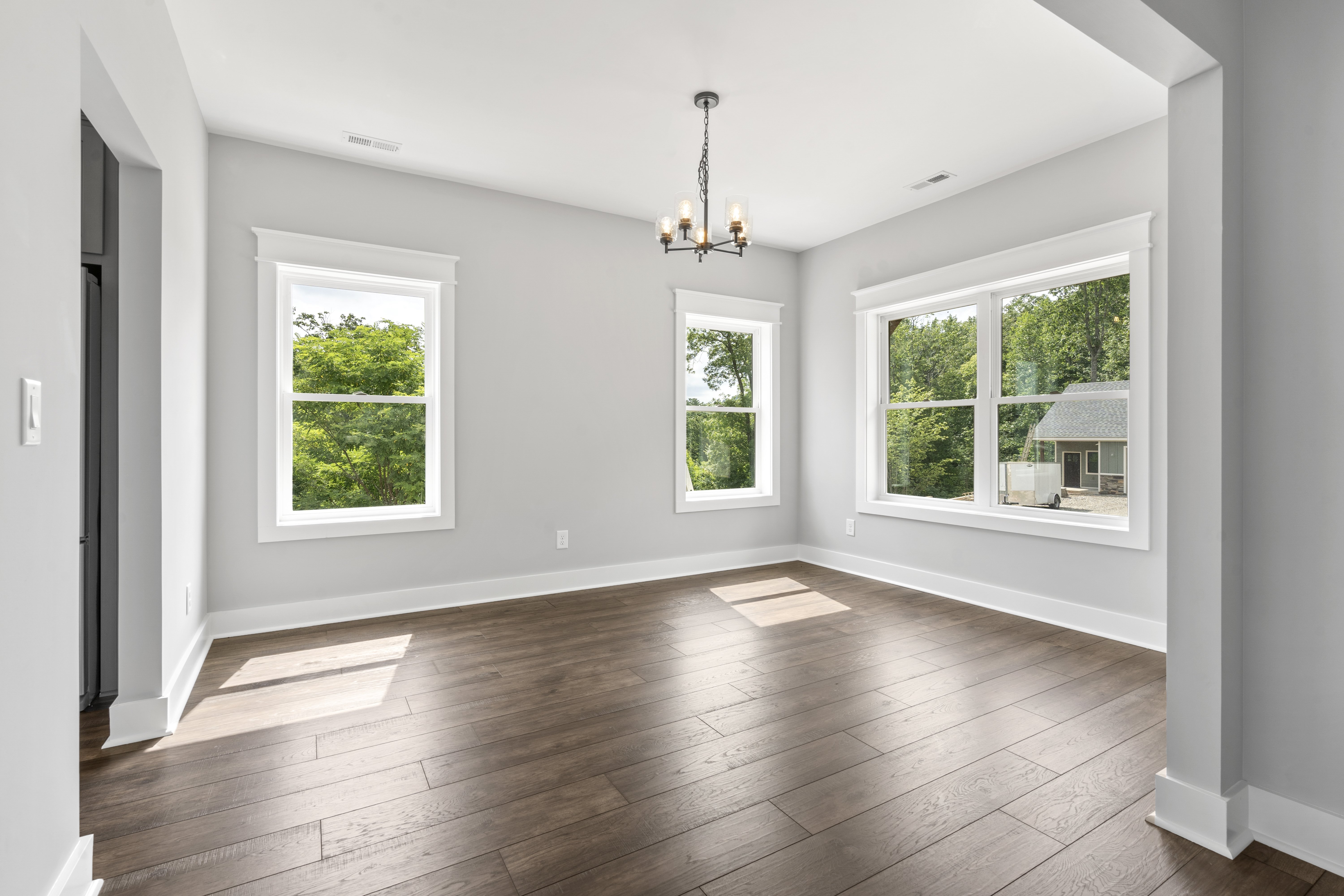 Spacious living room with vaulted ceilings and hardwood floors