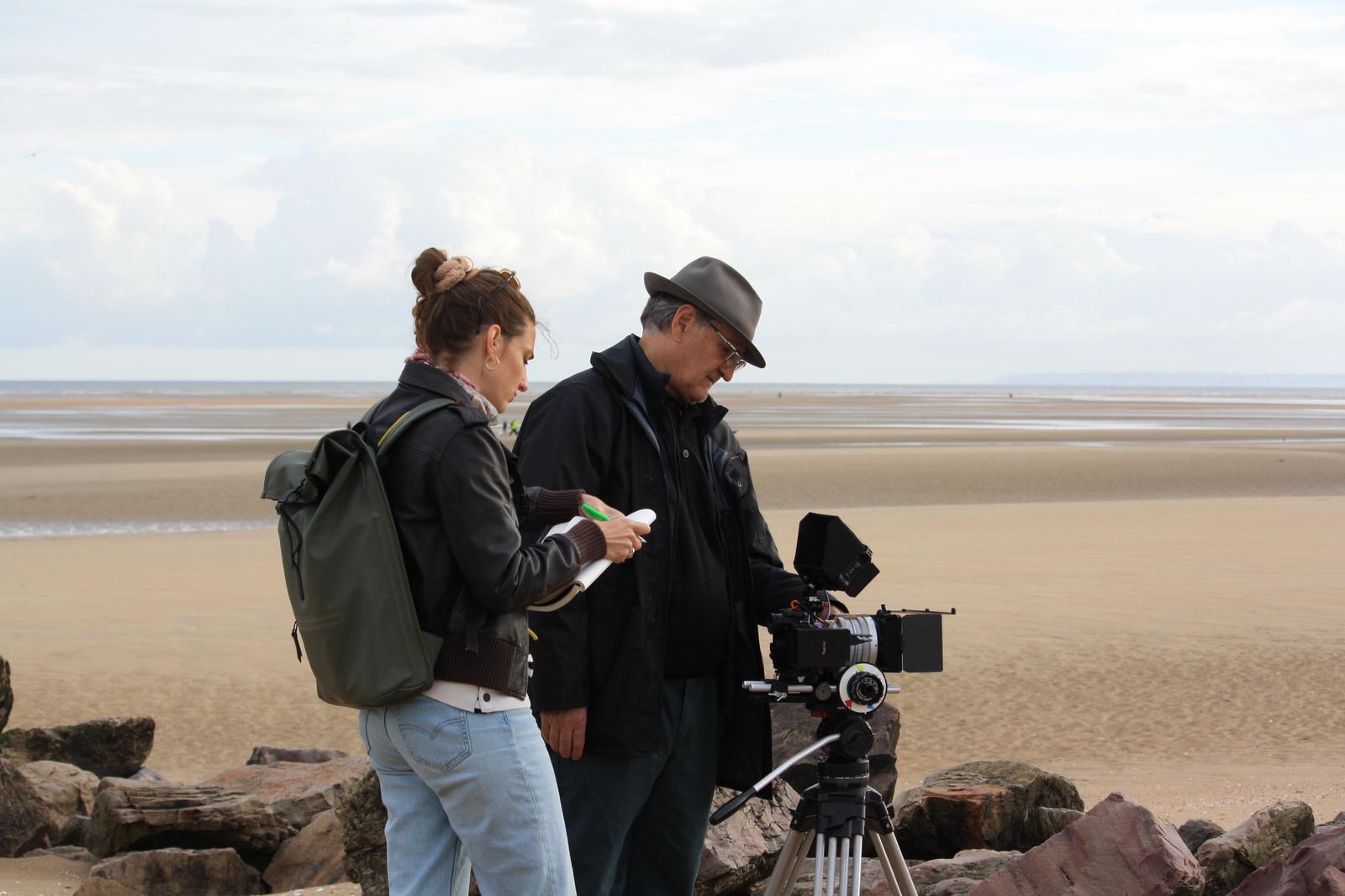 Woman in pink leather jacket crouching outdoors at night