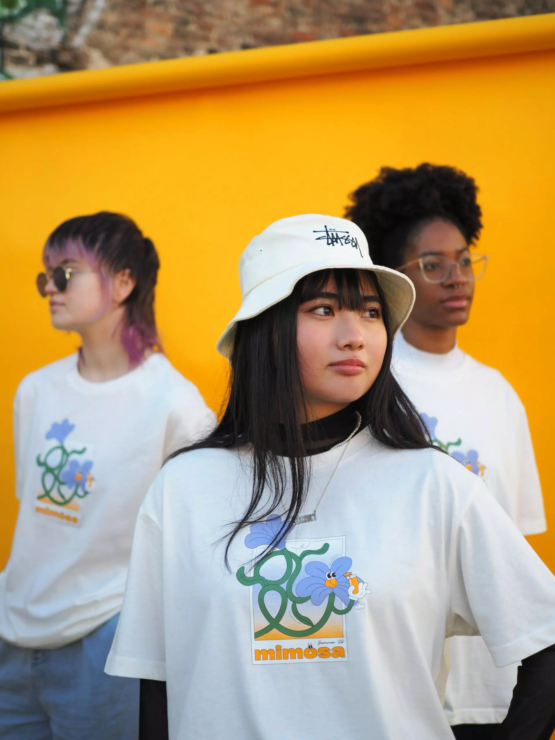 Portrait of people wearing a white mimosa agency t shirt