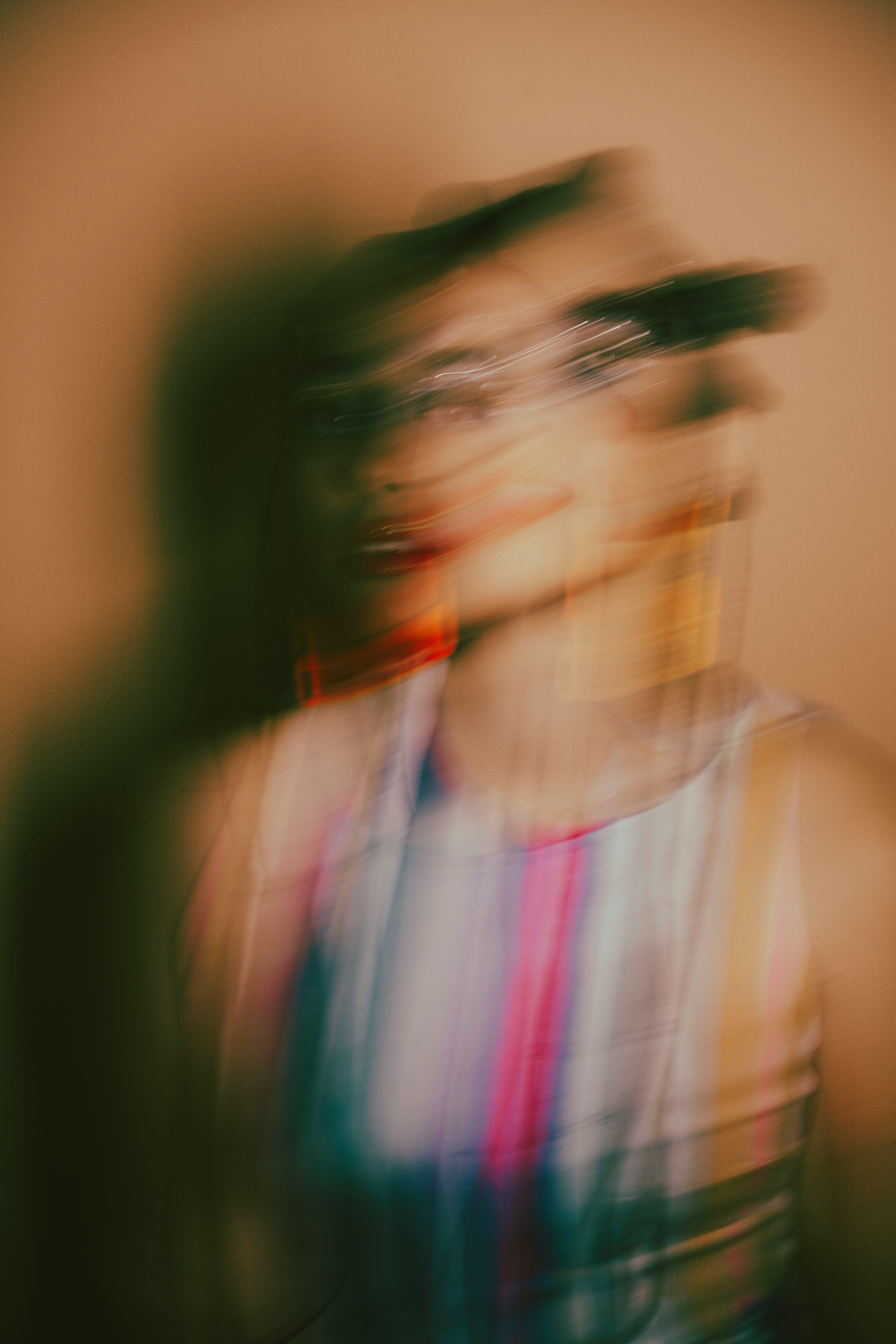 a blurry photo of a woman in a tank top