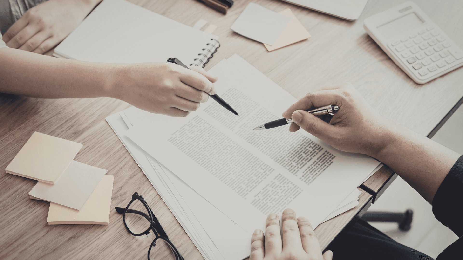 Administrative staff reviewing proof of delivery (POD) and invoice documents.