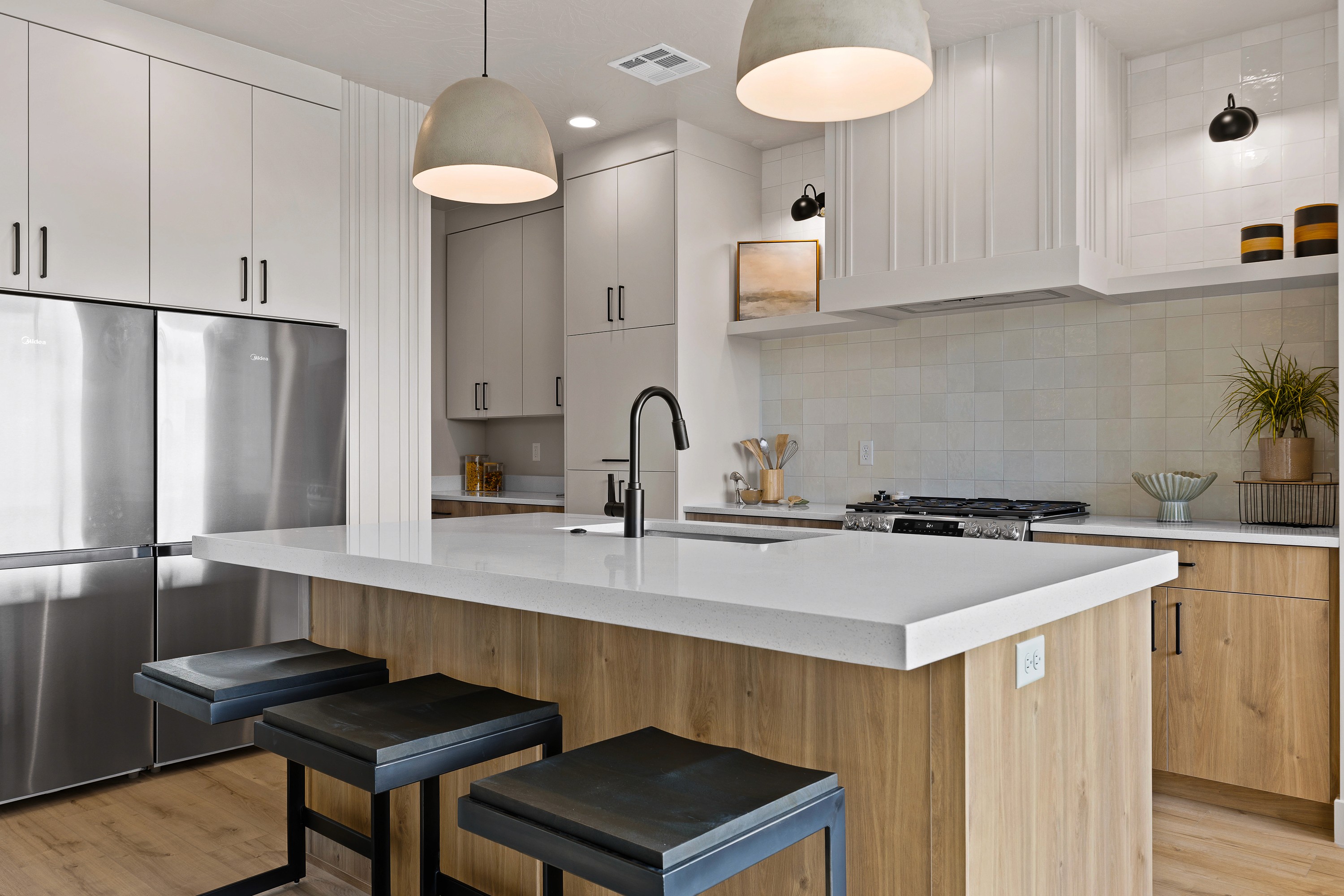 Kitchen in the BYSO House in Hurricane, Utah with light cabinetry, a functional island, and modern finishes.