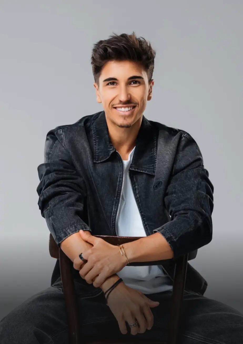 A smiling young man sitting on a chair