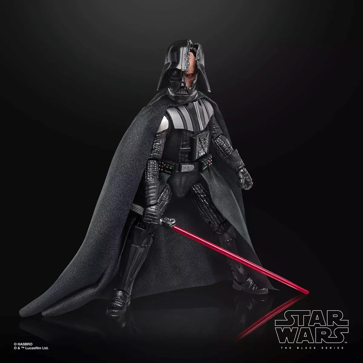 A detailed Star Wars Black Series action figure of Darth Vader is depicted in a dramatic pose with a glowing red lightsaber and intricate costume details, set against a stark black background.