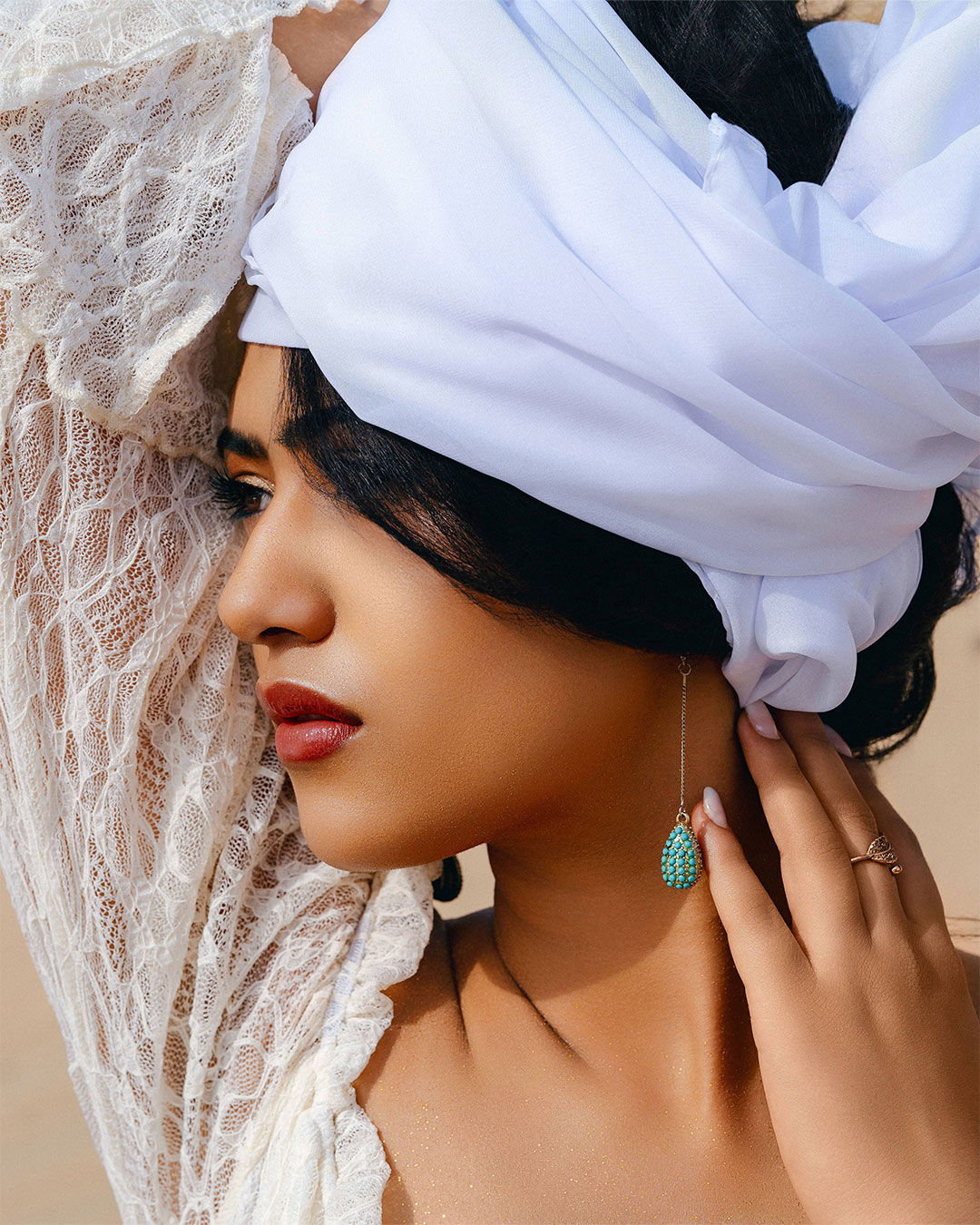 A captivating photoshoot of a woman in the golden dunes of the Dubai Desert Safari, capturing flowing movement, natural light, and the serene beauty of the desert landscape.