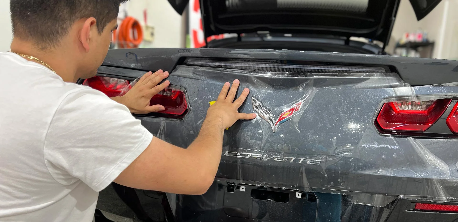 Vehicle detailing showing application of clear bra film