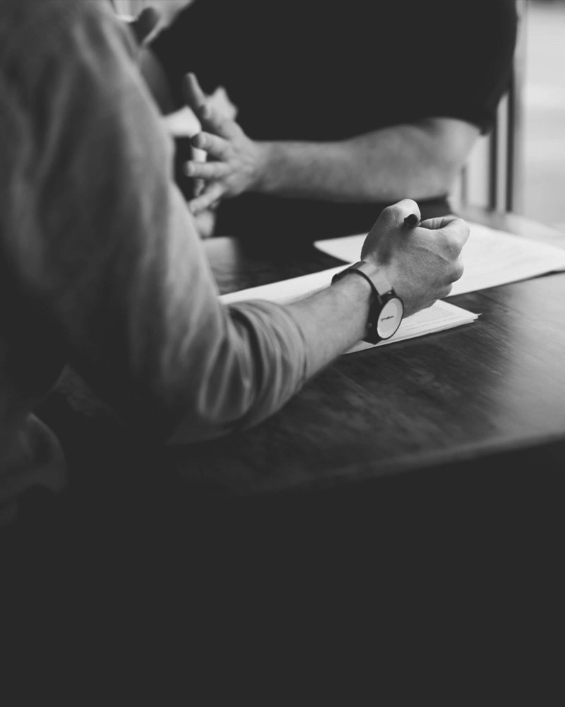 Visual for Strategy Service. Close-up of a smartwatch and handwritten notes representing product and business strategy planning.