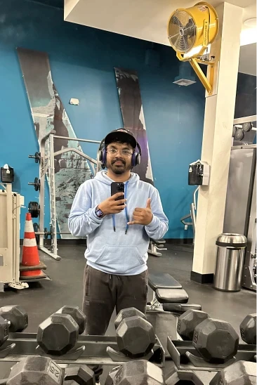 A man holding a camera up to a tripod