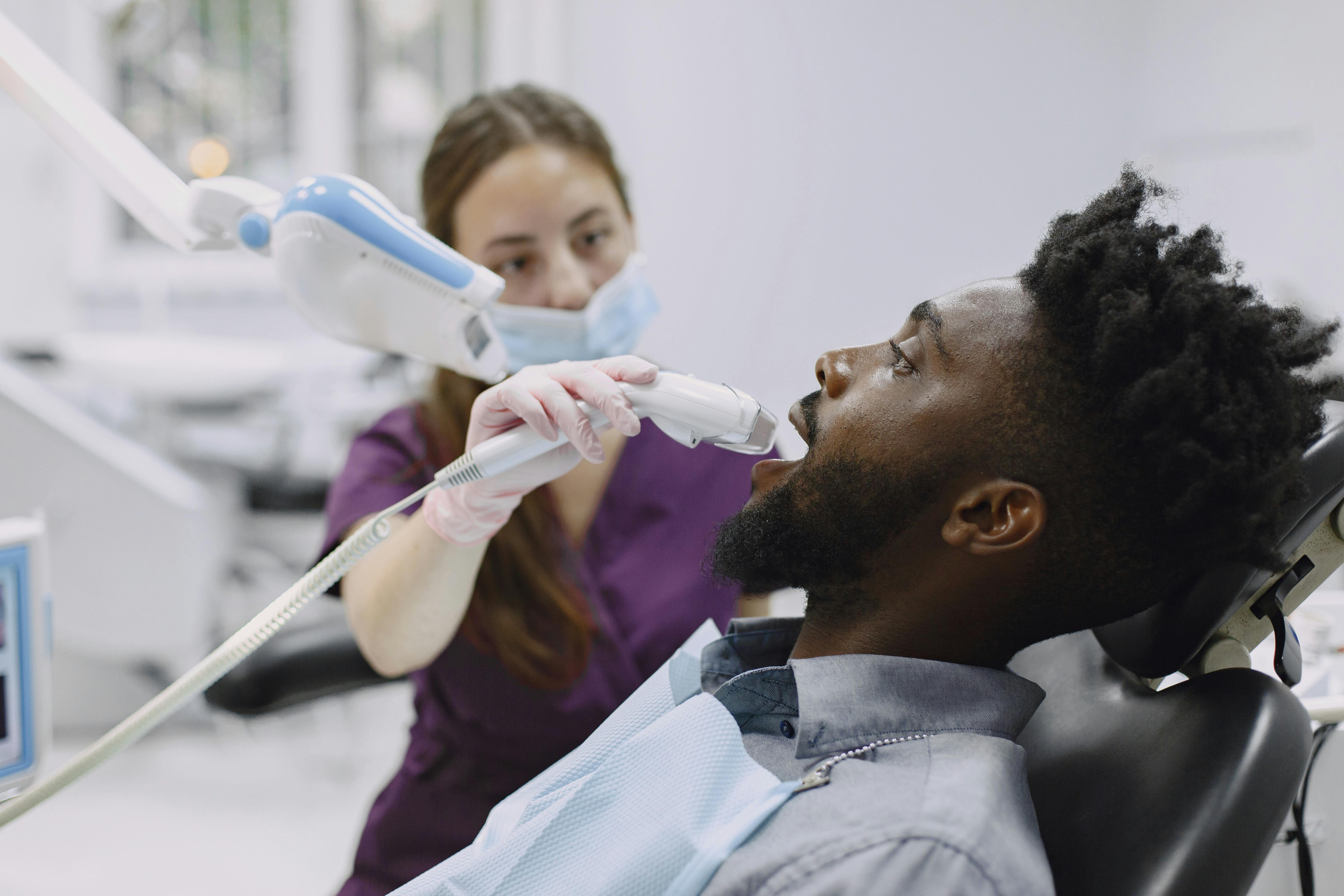 dental hygienist taking xrays of patient's teeth