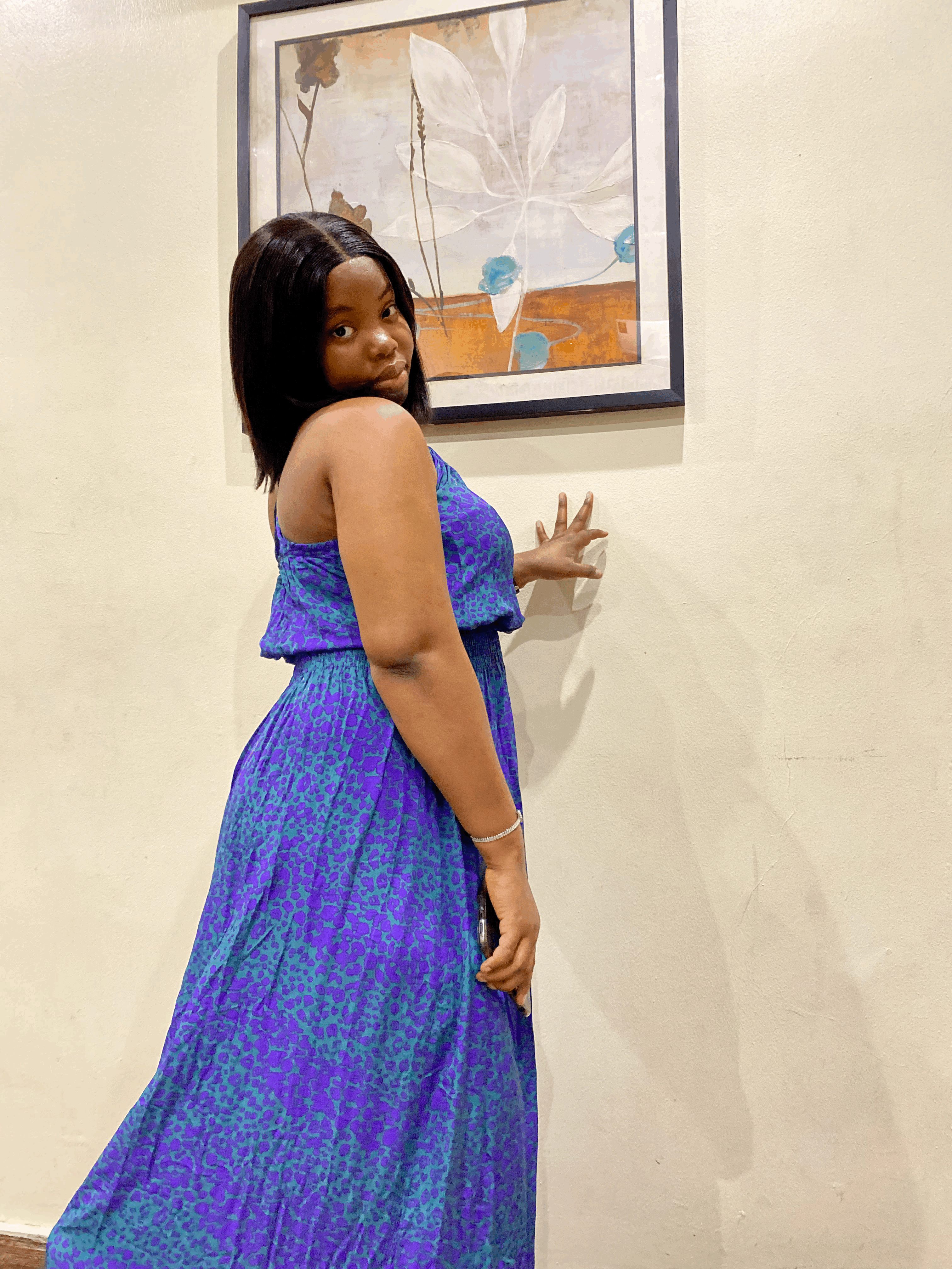 Girl posing in front of a wall portrait