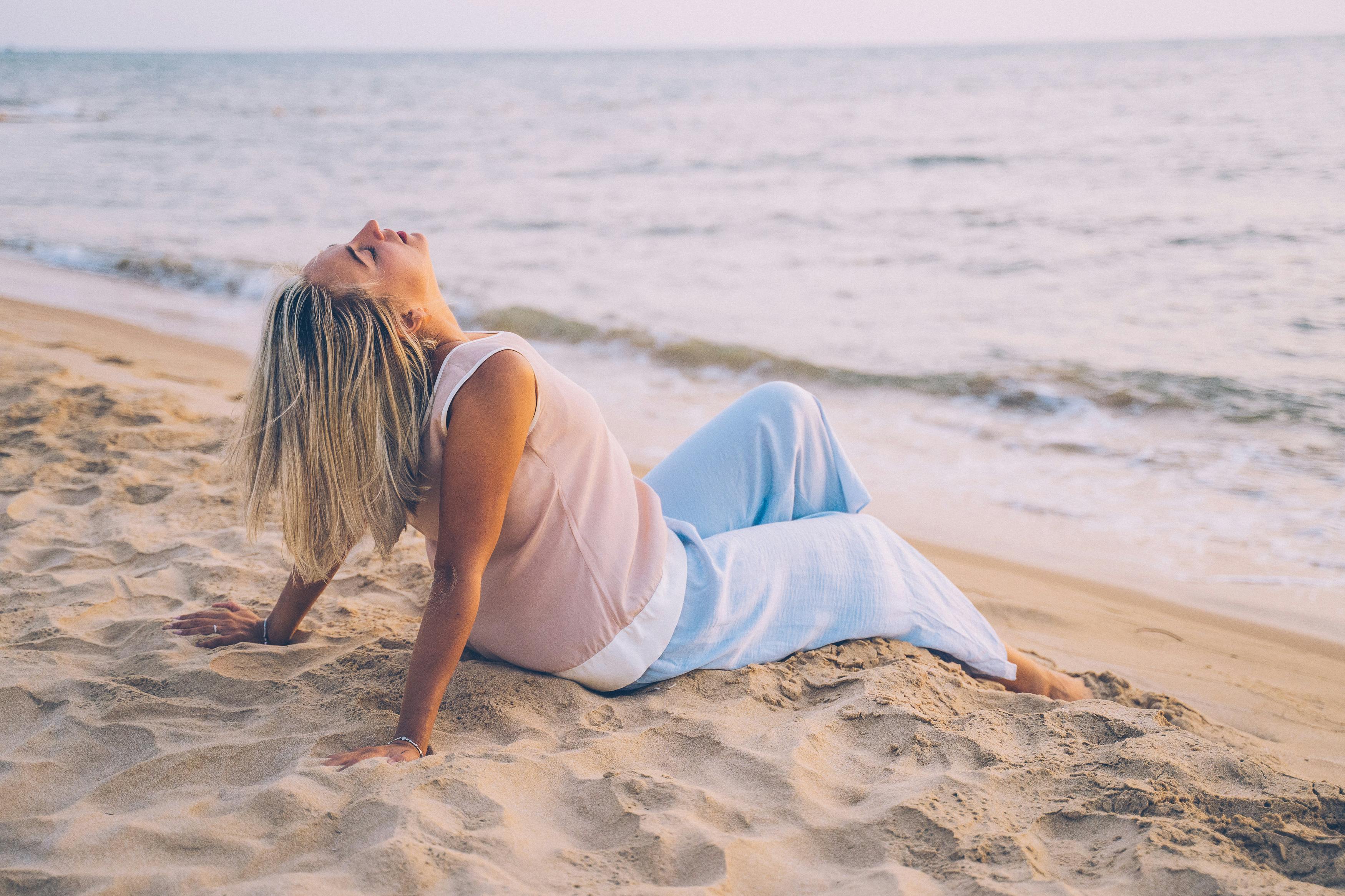 Woman using grounding techniques for dissociation by connecting feet to the floor and breathing into her belly