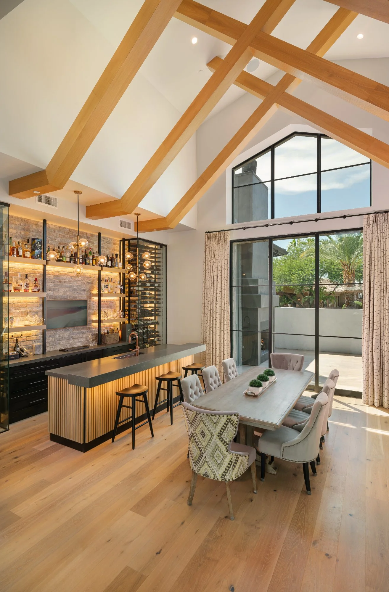 nfinity pool blending into the ocean view, minimalist sun loungers in soft neutral fabric, curved architecture