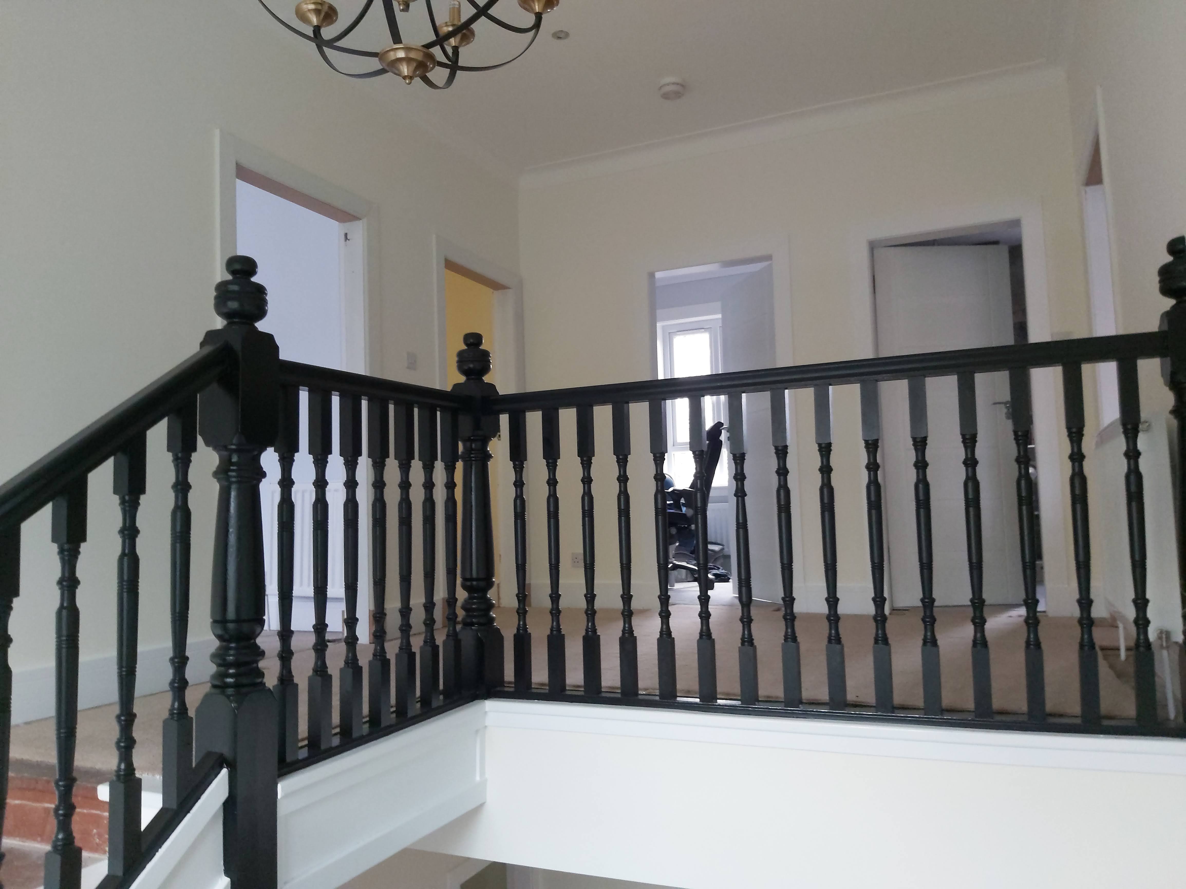 A black guard rail leading up a set of stairs