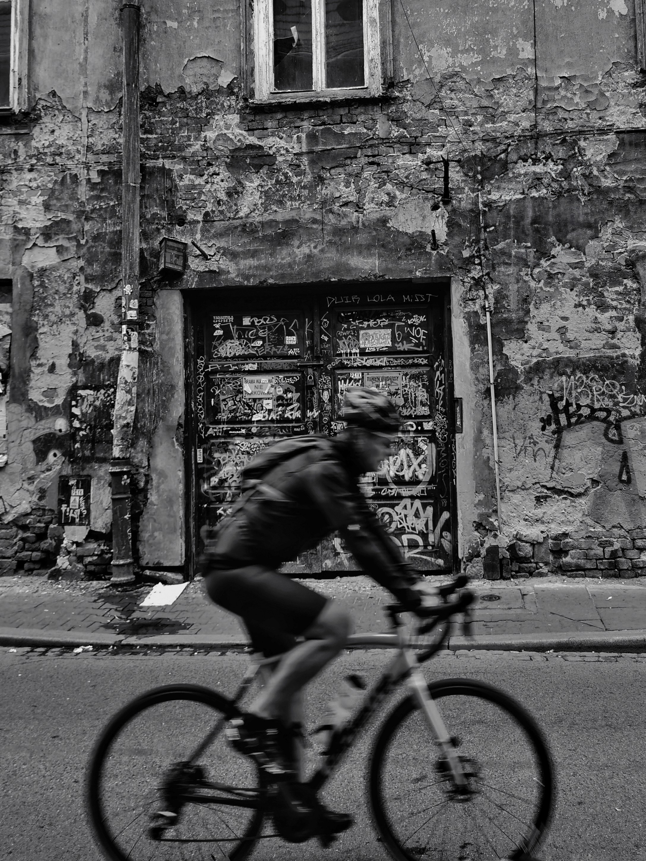 Person sitting on a ledge overlooking New York City skyline