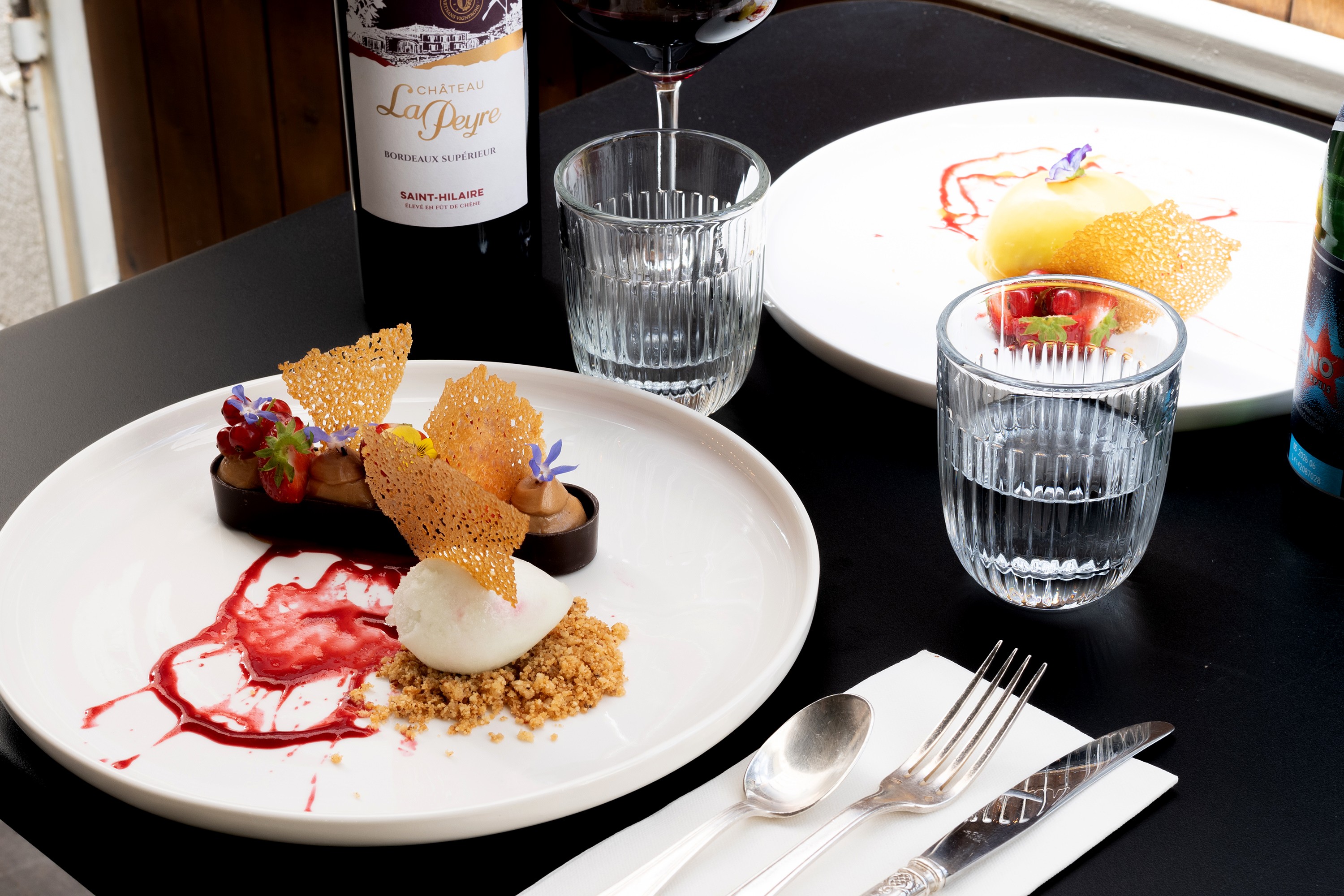 two glass of iced tea with some orange fruit around them