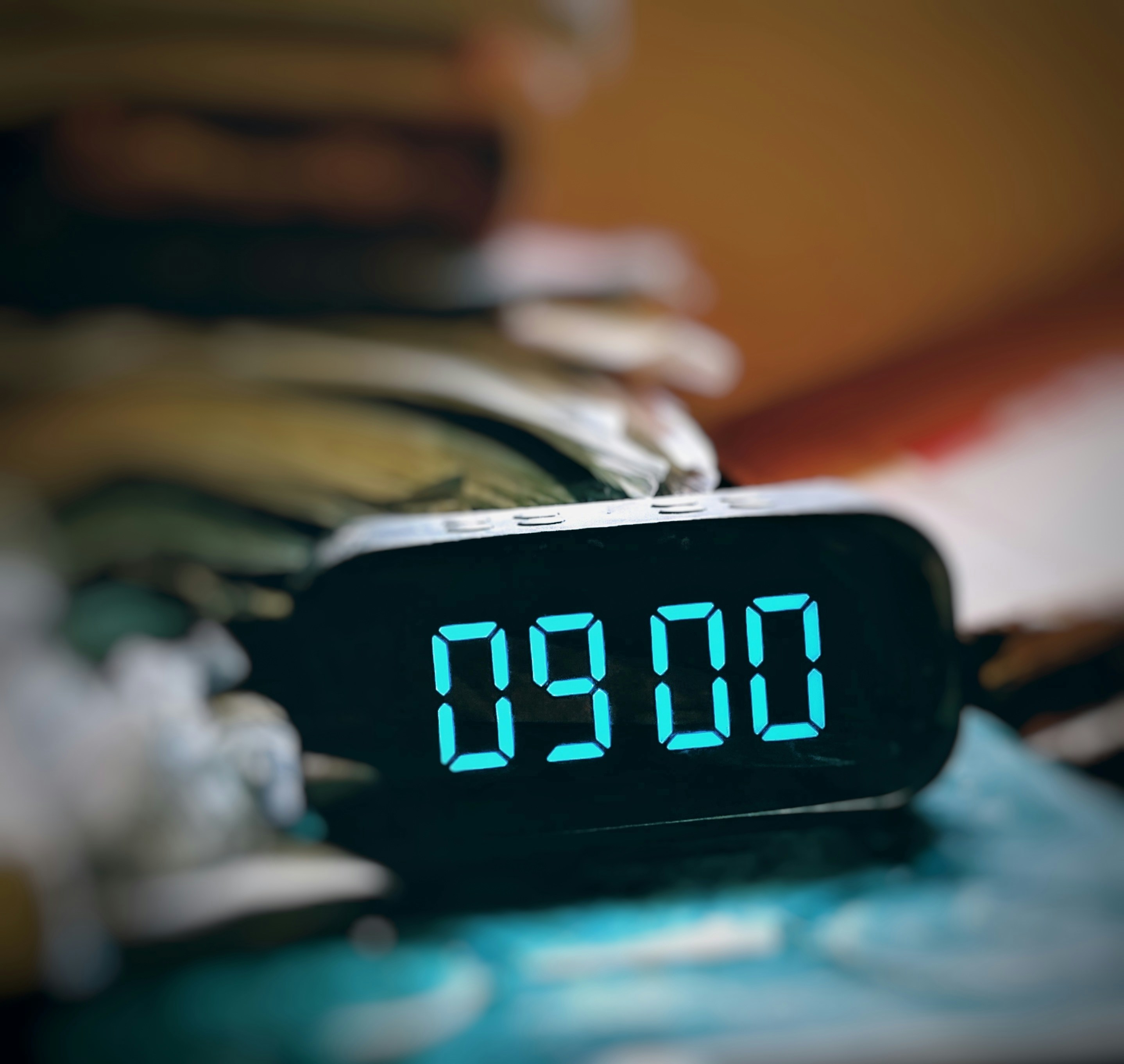 The time is nine o'clock, displayed on a clock.