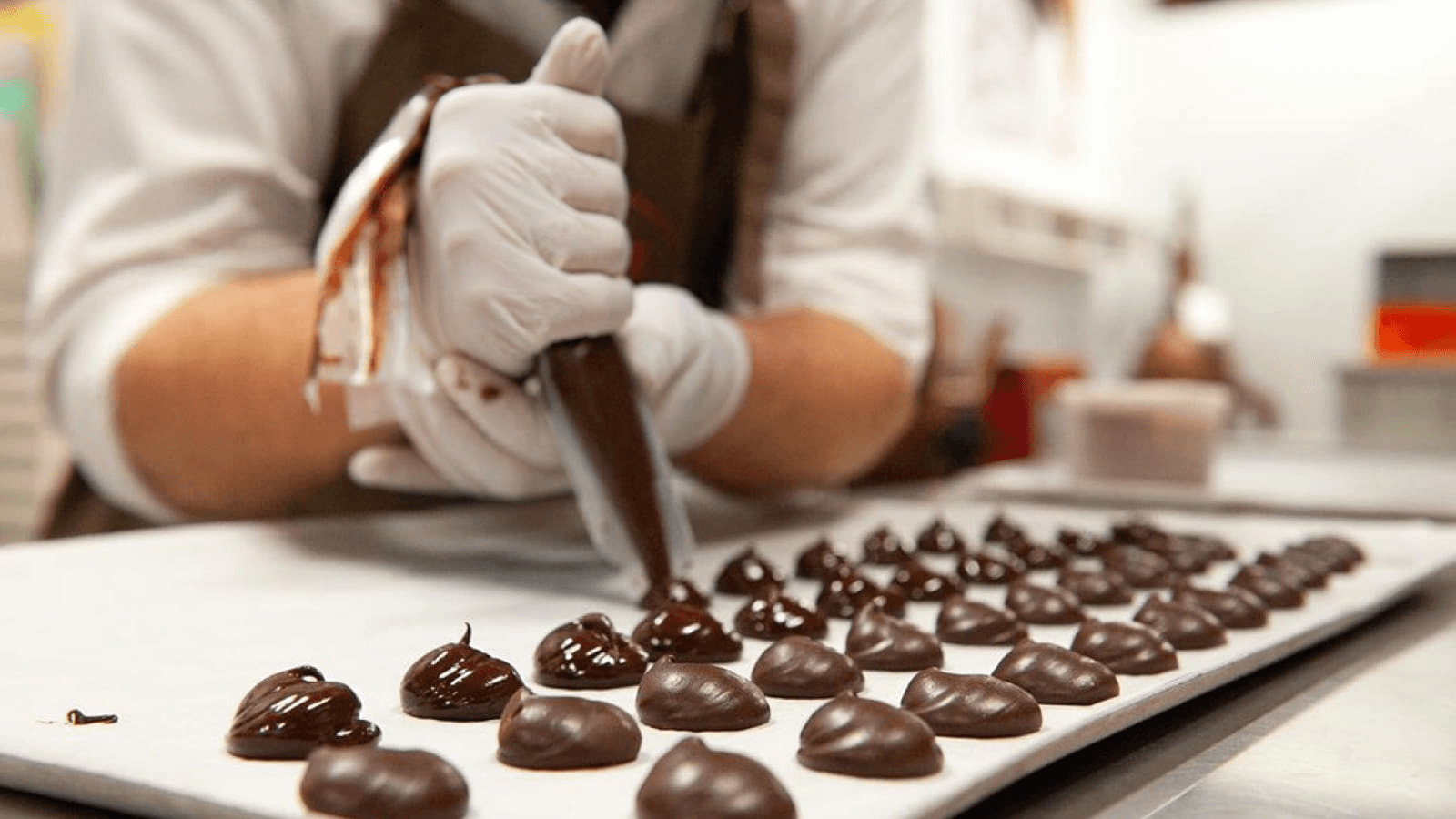 une personne poche du chocolat artisanale sur une plaque de cuisson