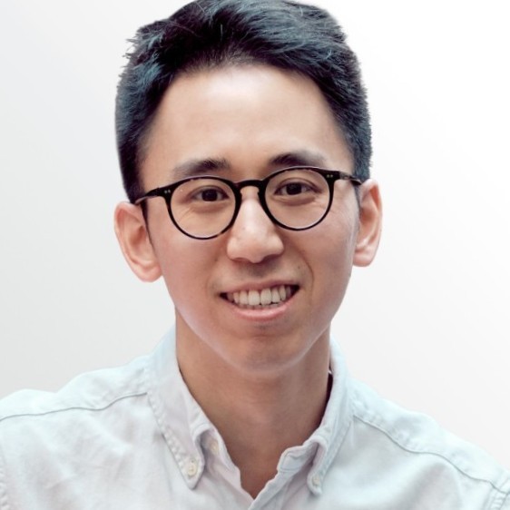 Smiling man with a white shirt on a white background.