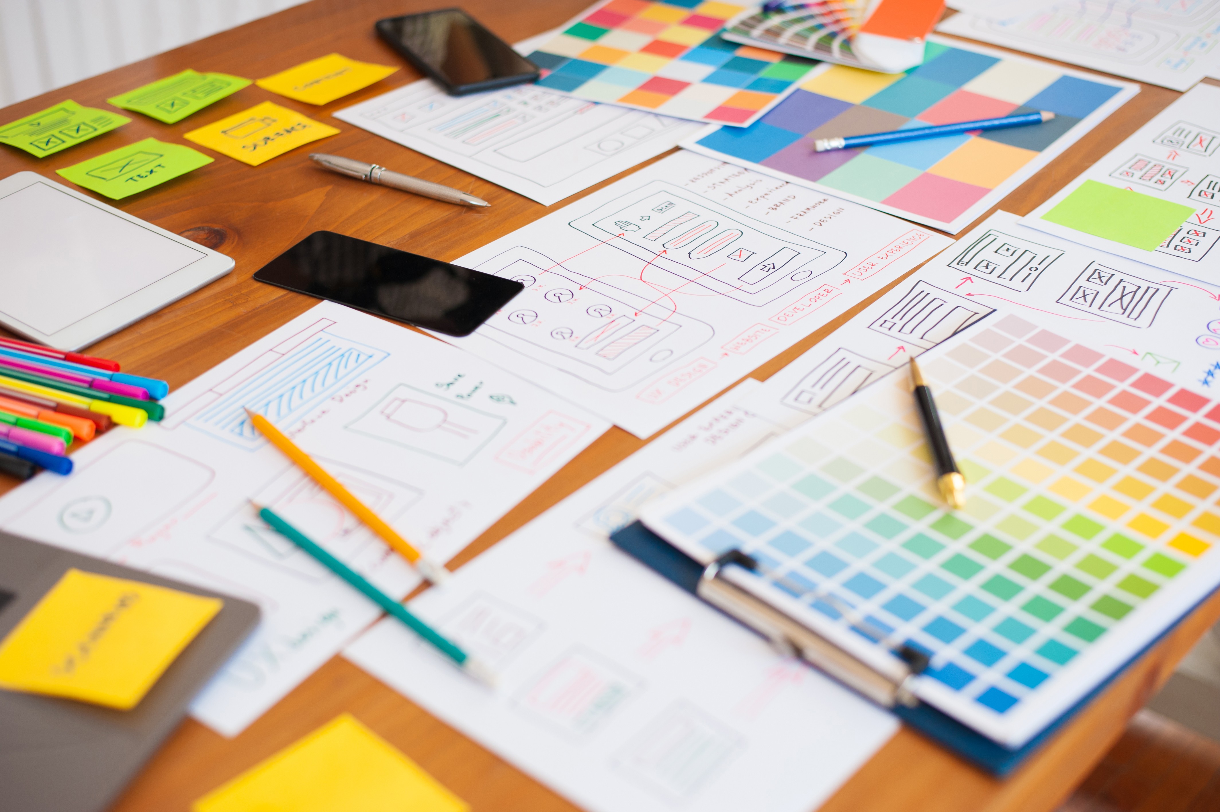 Image of Flat-lay of design tools, color swatches, typography samples, and sketches