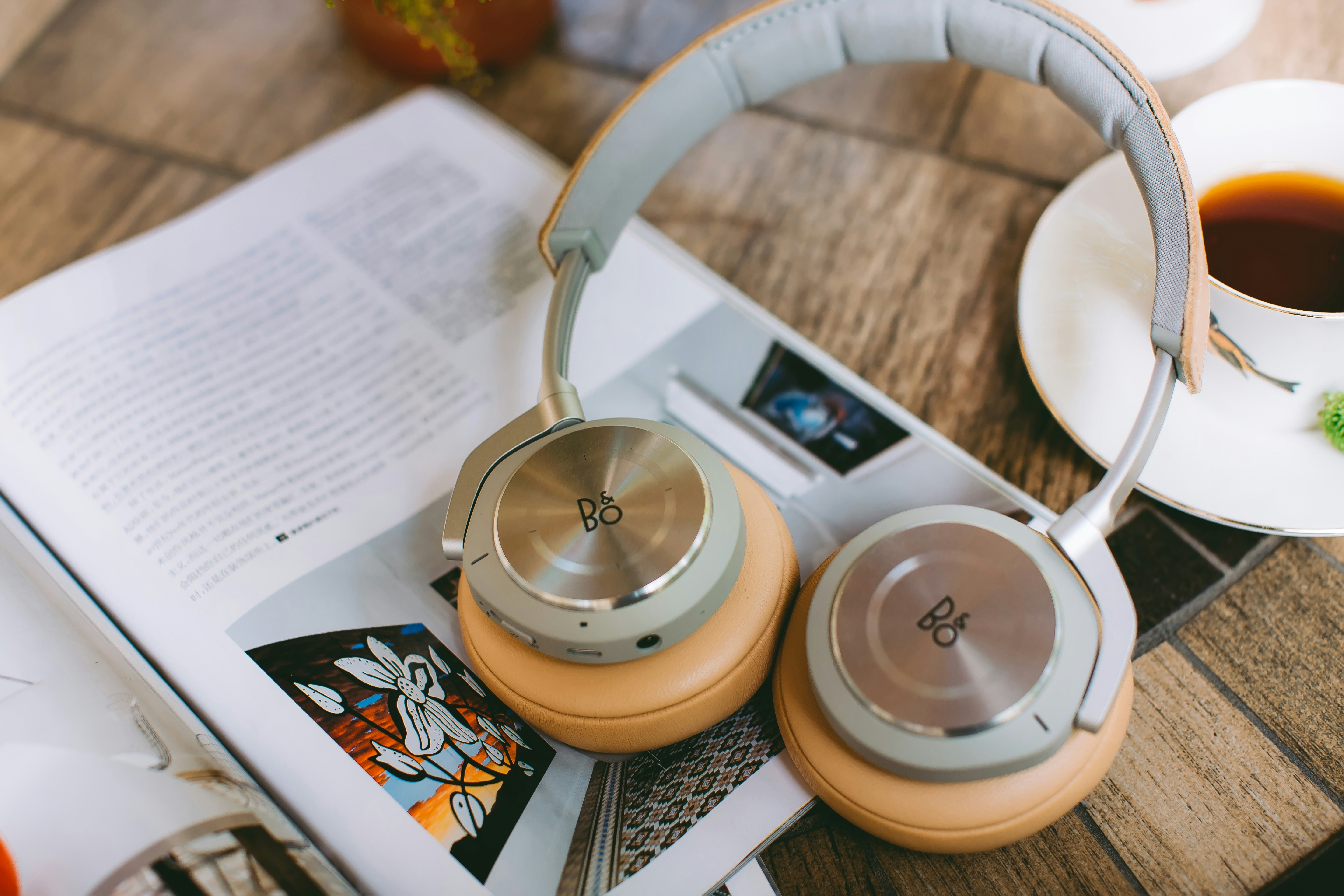 headphone over a magzine - Turn Physical Book into Audiobook App