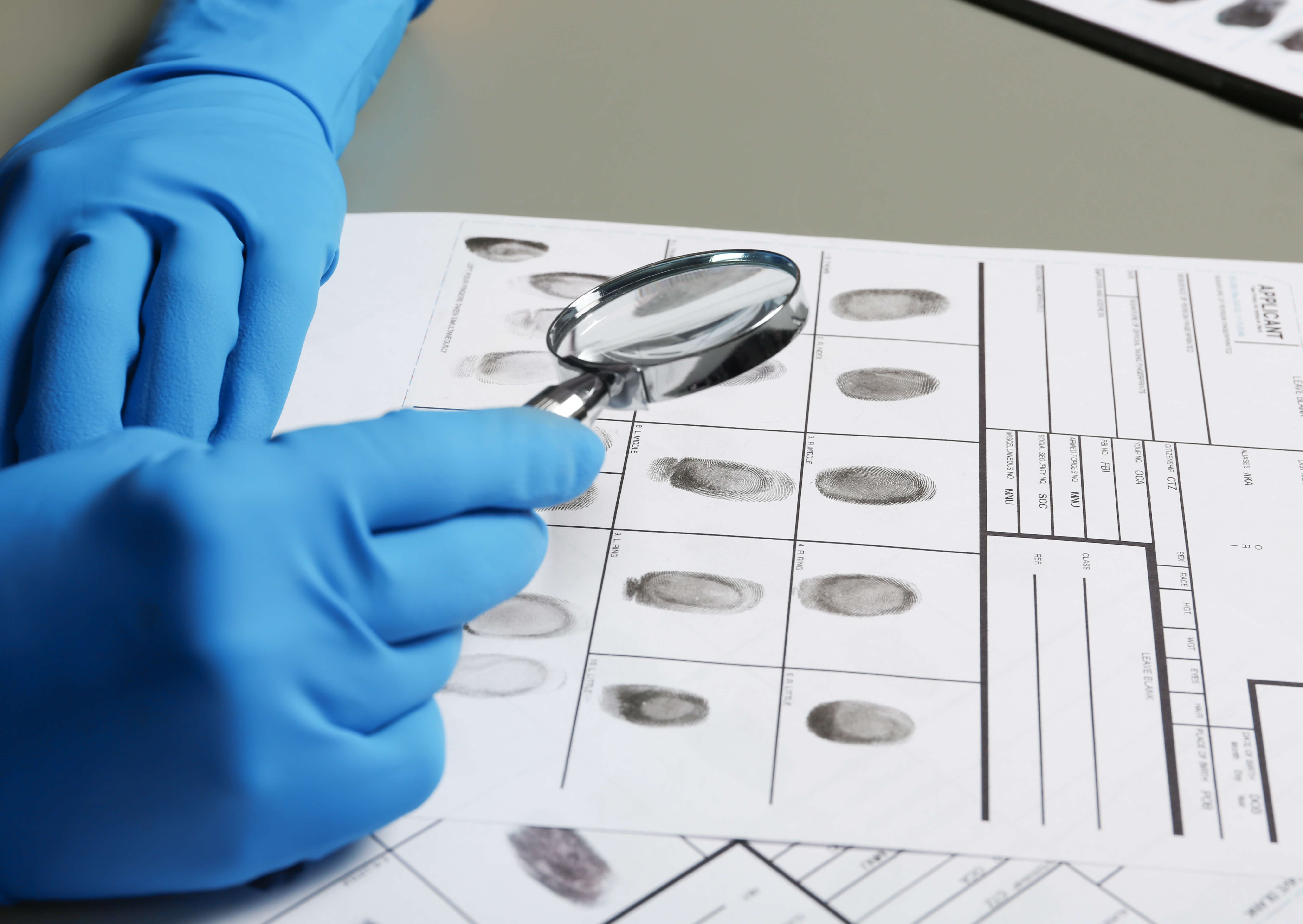 criminalistic officer analyzing fingerprints