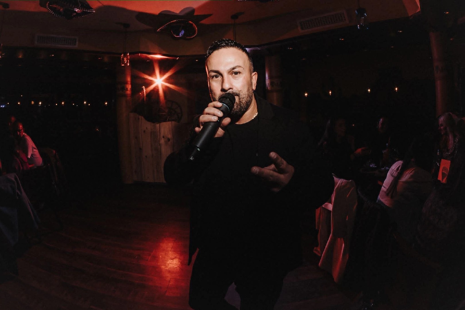 woman in brown long-sleeved top standing beside wall