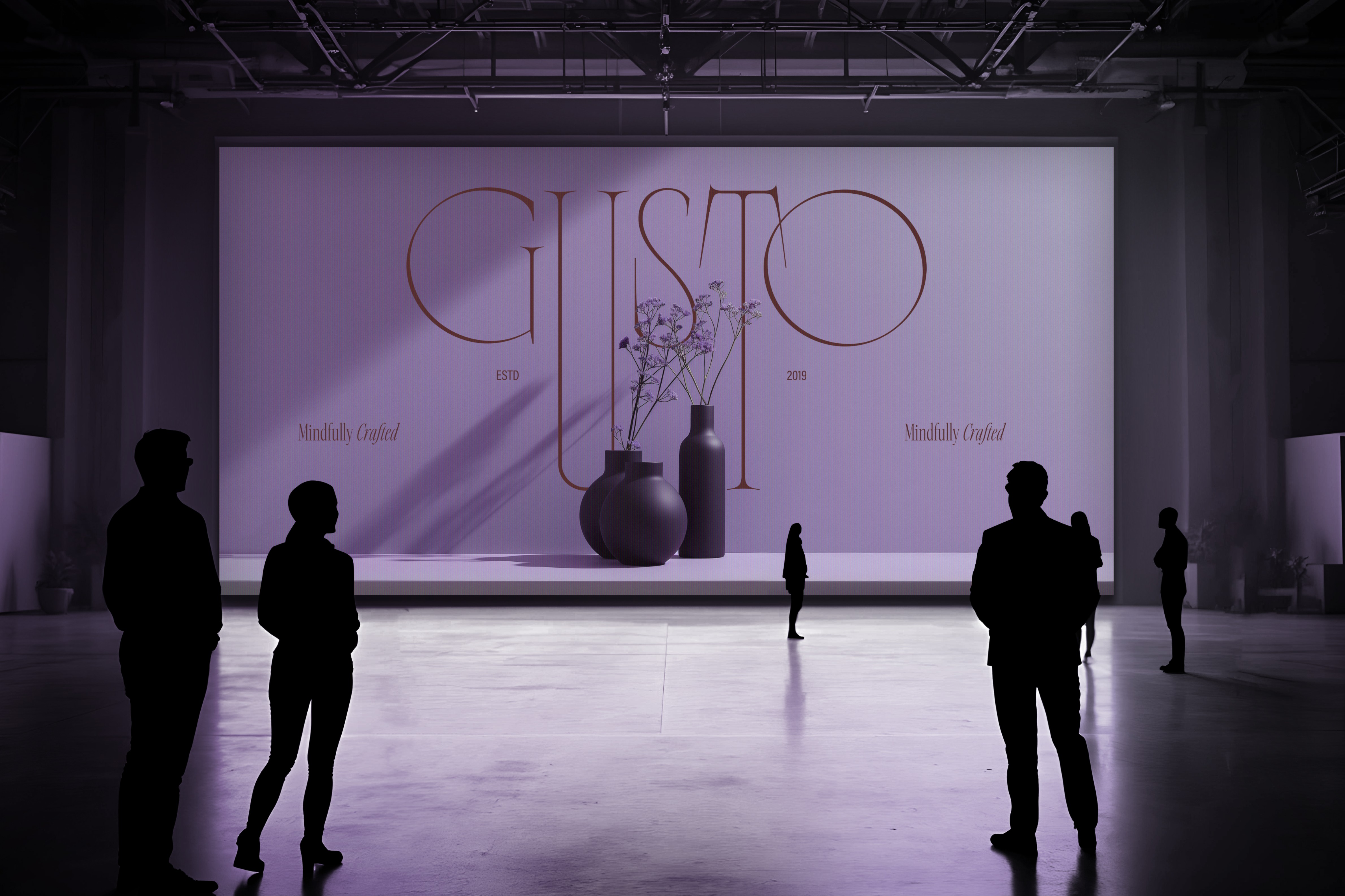 Elegant brand identity for Gusto, displayed on a large projection screen with silhouetted figures, emphasizing the brand’s sophisticated aesthetic.
