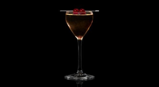 A closeup of a Bitter, Autumn Casa Calvados drink against a dark background.