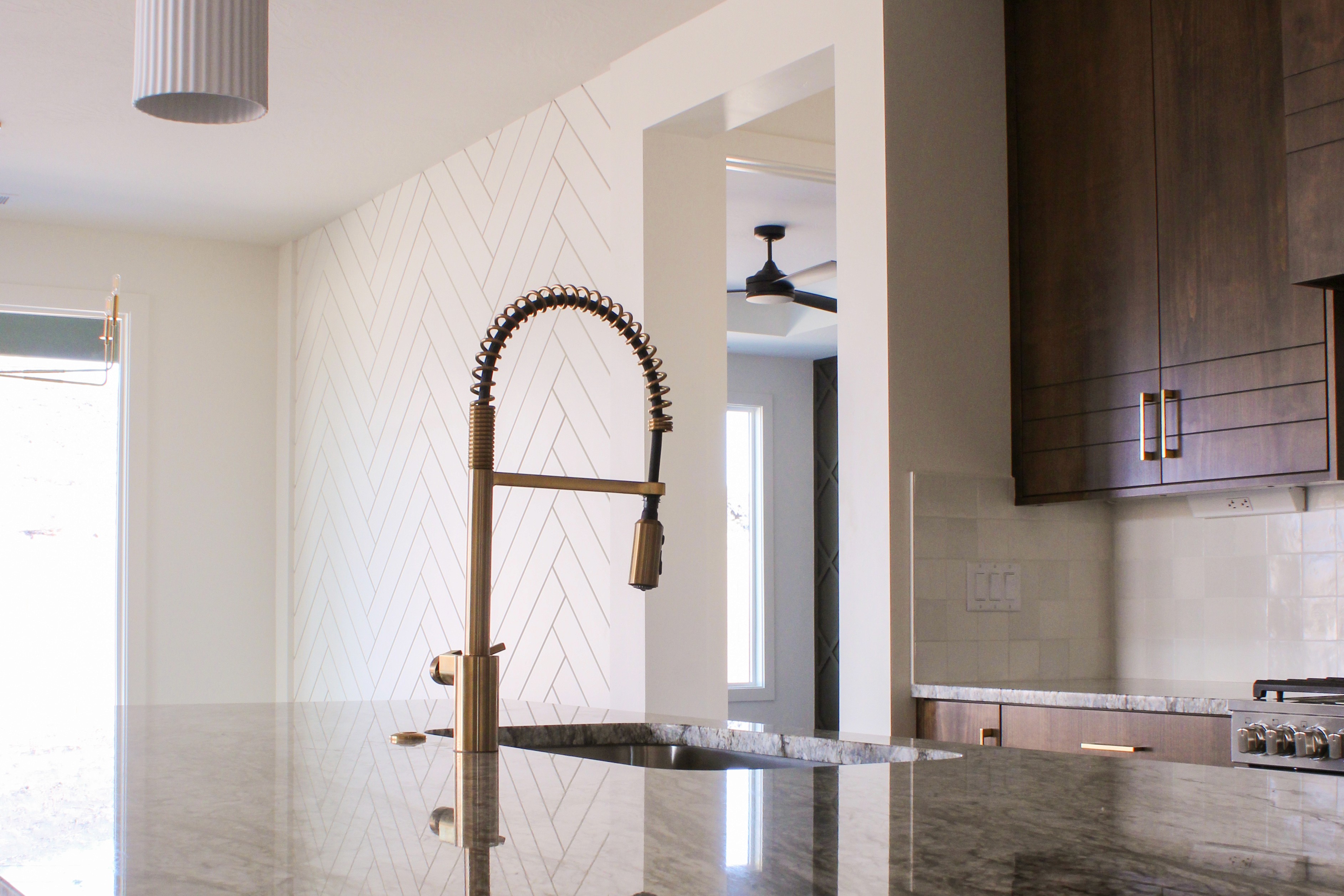 Two-toned gold and black kitchen faucet in a Hurricane, Utah custom home.