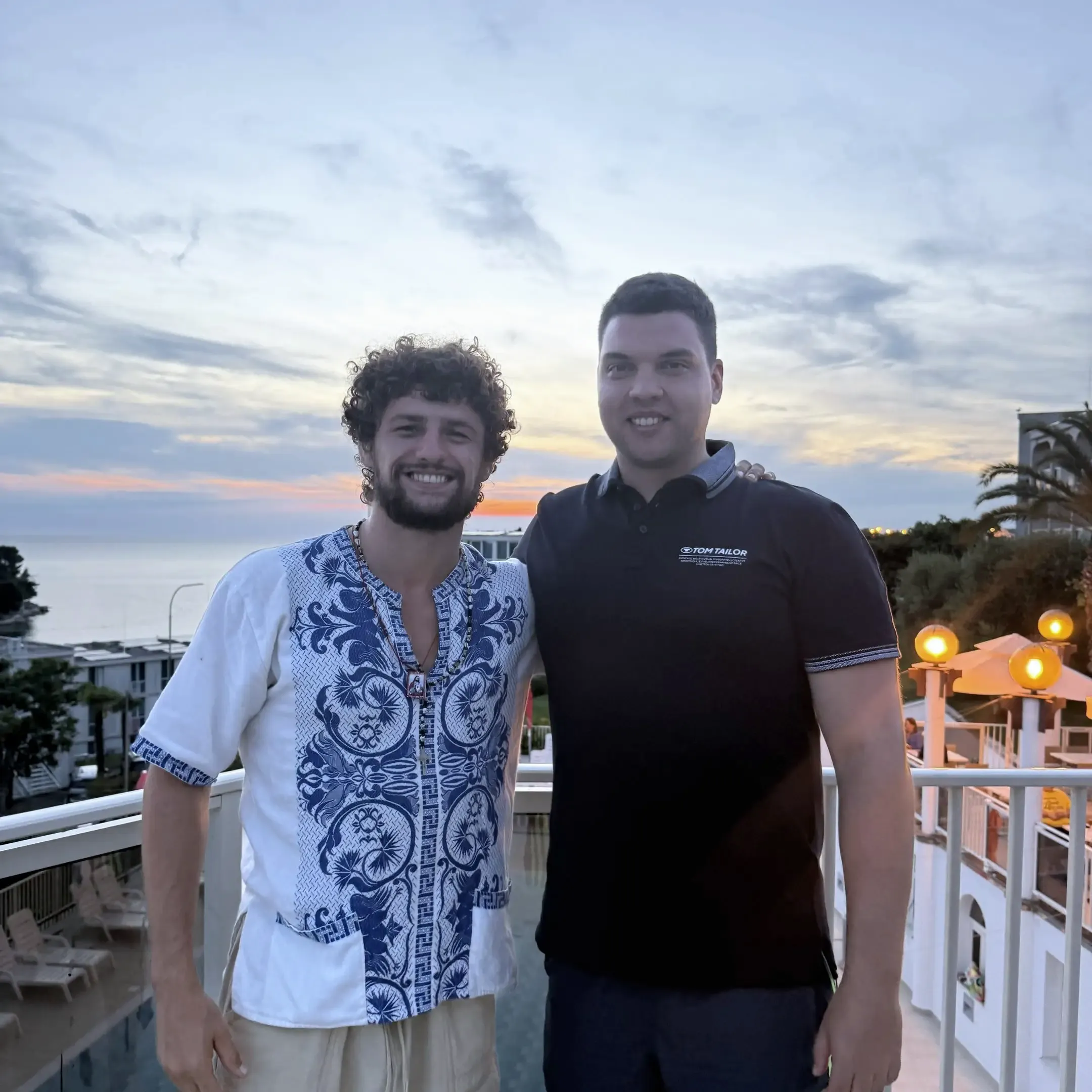 Monochrome product shot: black-capped cosmetic bottle with dynamic water splash on a clean white background.