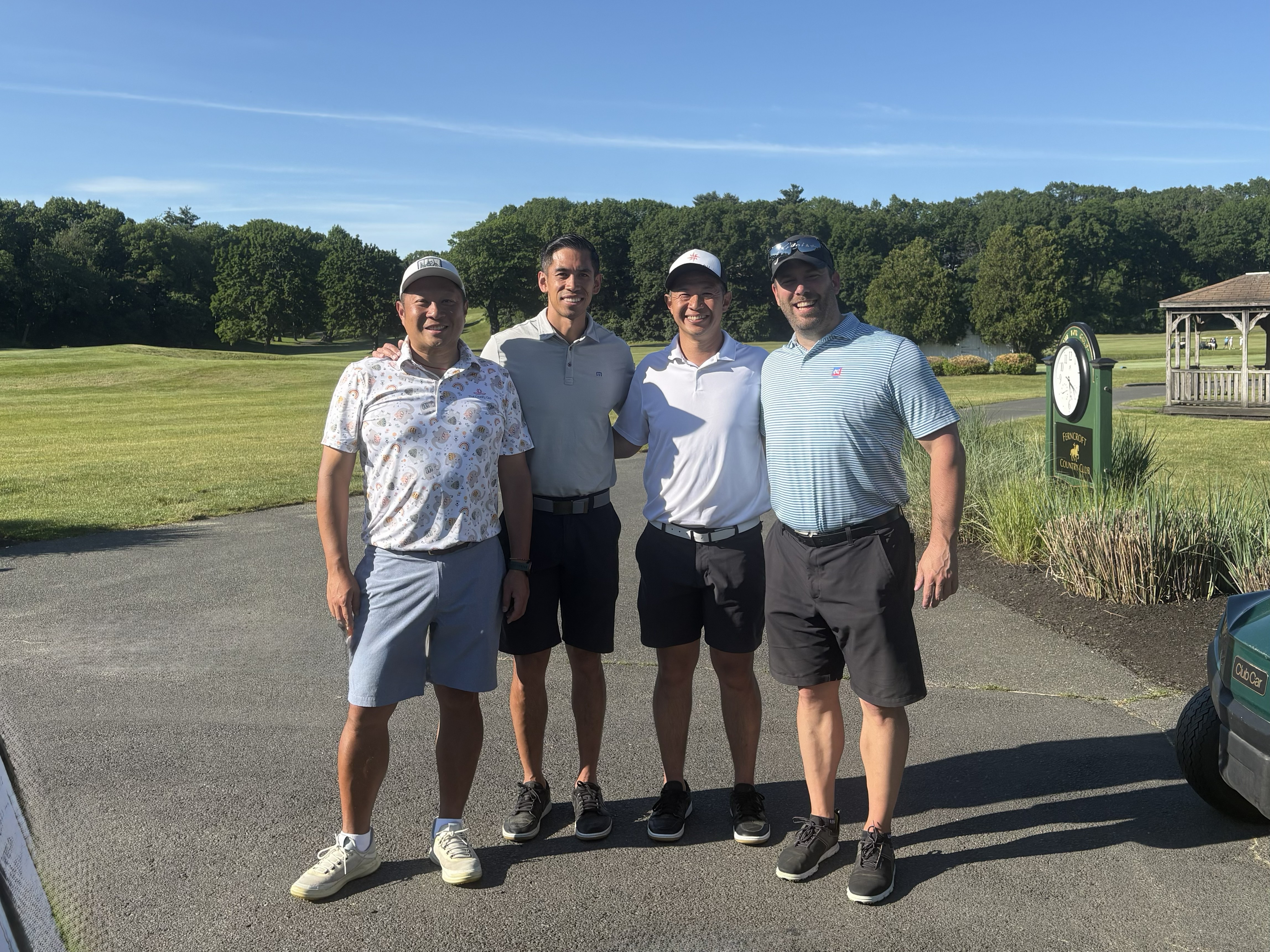 Four golfers posing on the course at the St. Mary’s golf tournament