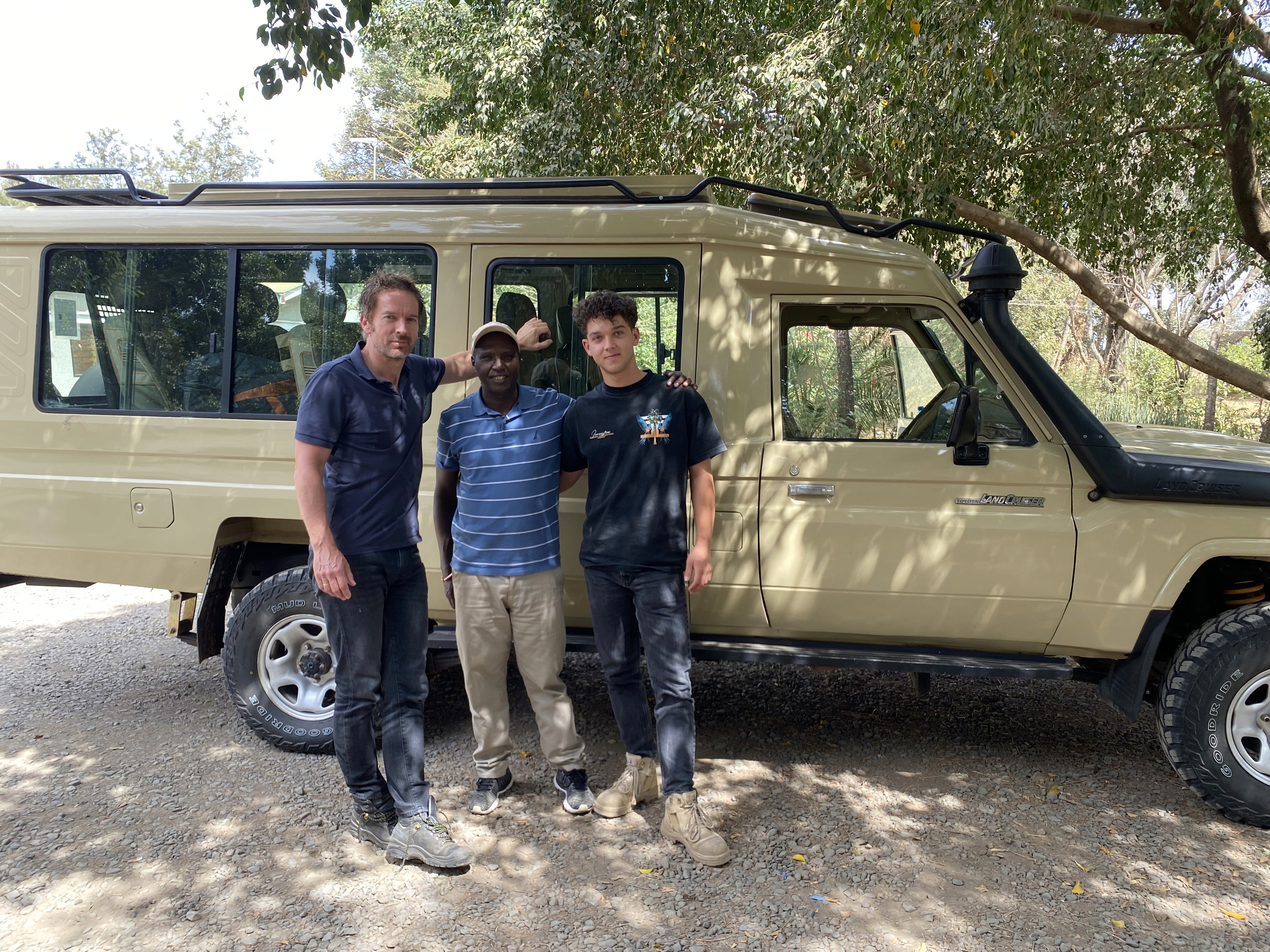 Travellers with their guide at the Kembe Safari vehicle