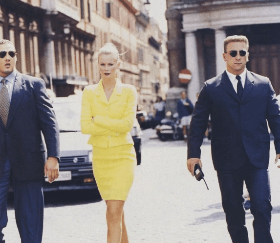 Man wearing an oversized green outfit with cartoon graphic