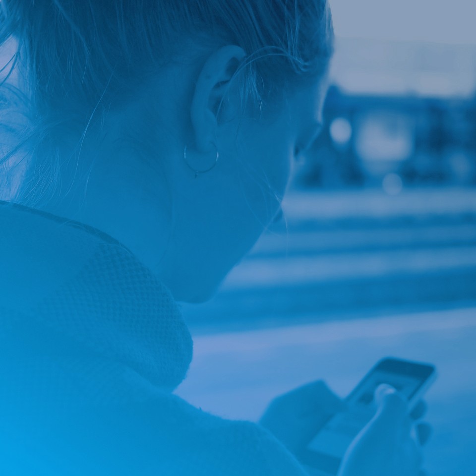 Woman holding a phone for the MVNO section