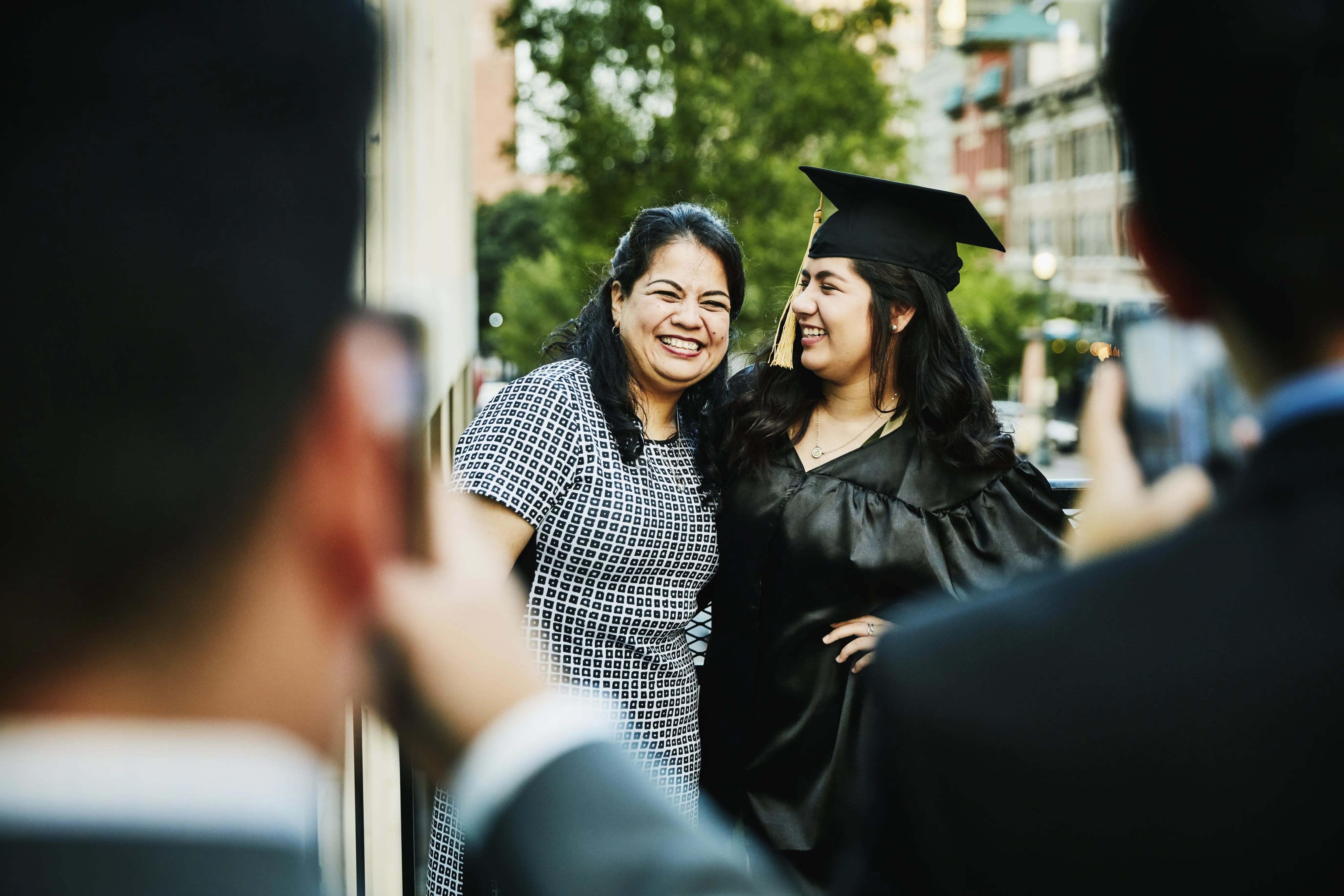 Mother and daughter smiling at graduation ceremony 