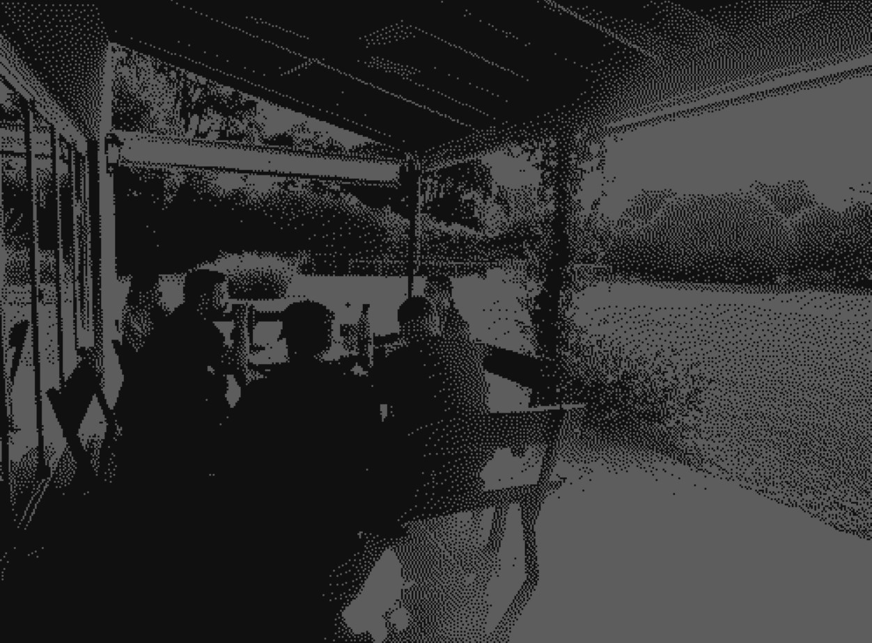 Four diverse professionals collaboratively working on a laptop, with one person pointing at the screen while others observe.