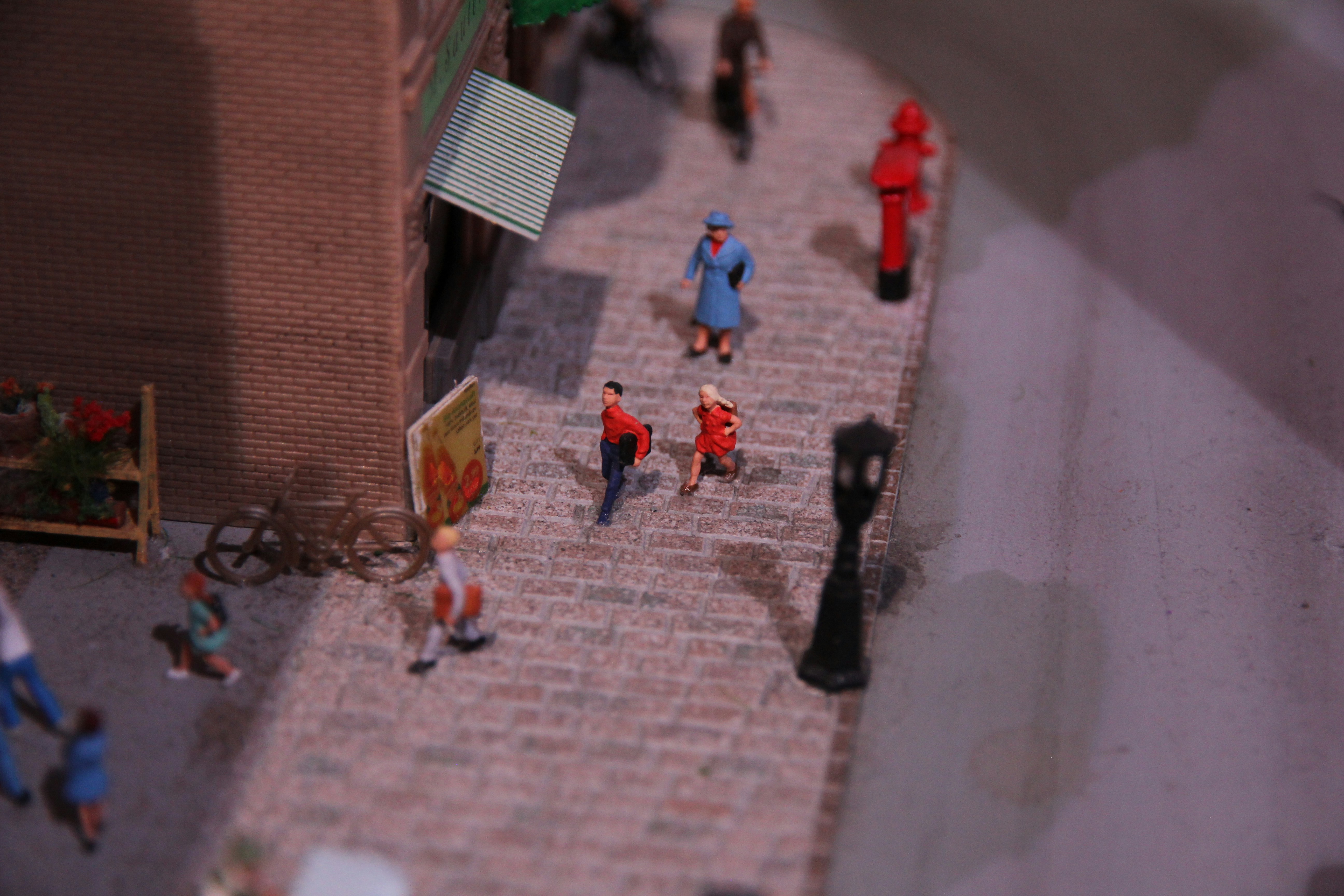 Miniature city scene with tiny people walking on a street model