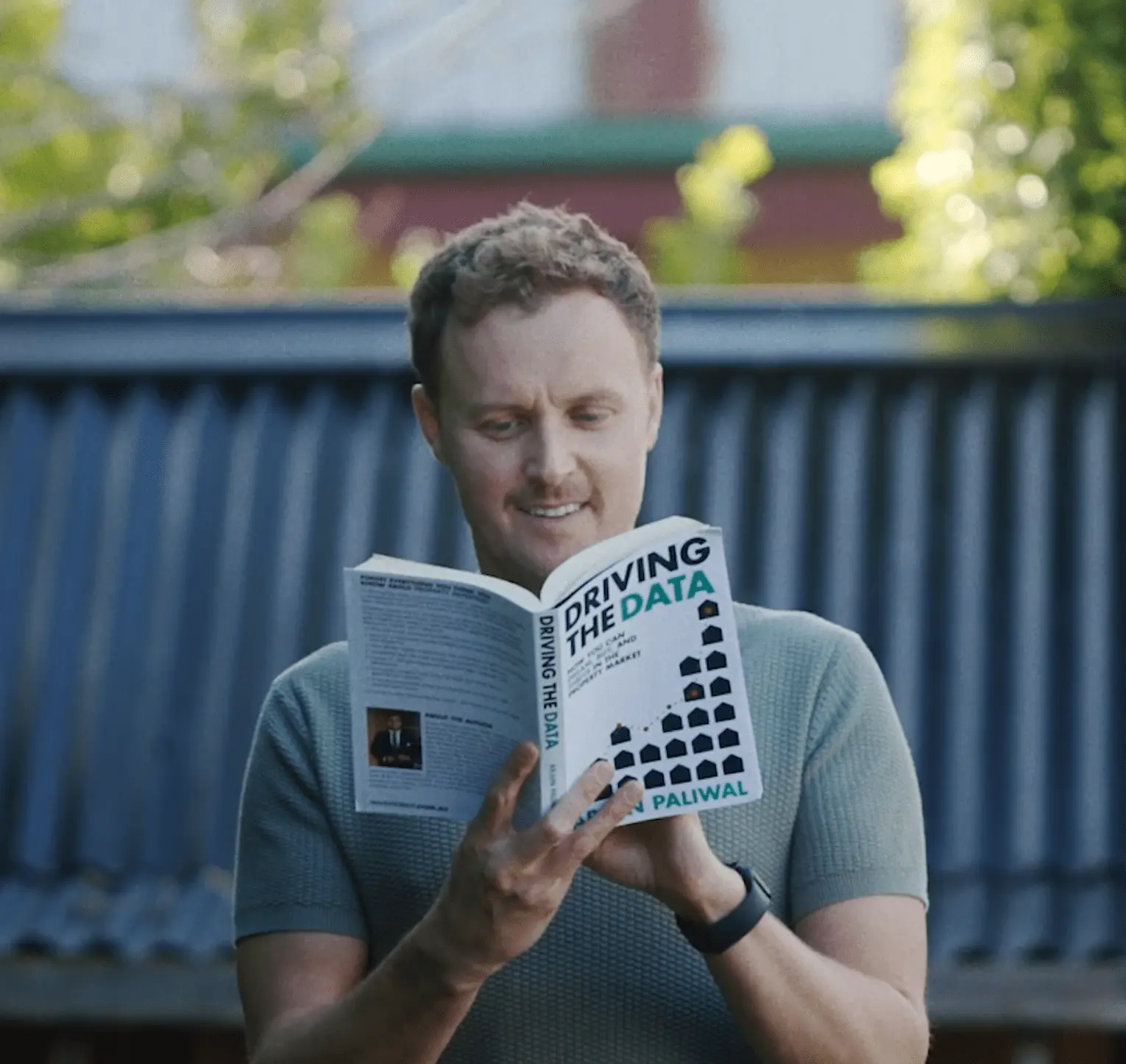 Man reading "Driving the Data" book