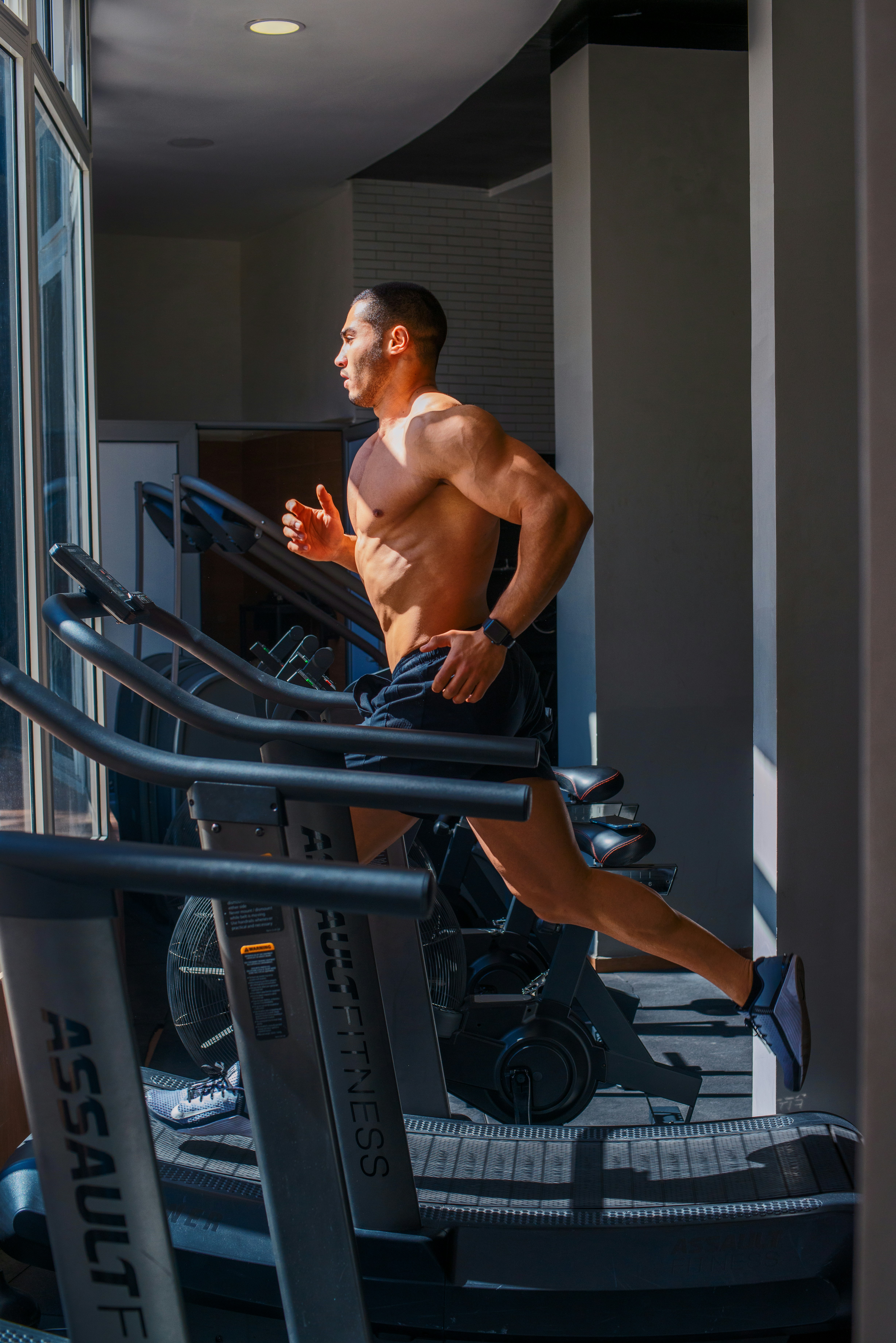 a man running on a treadmill in a gym