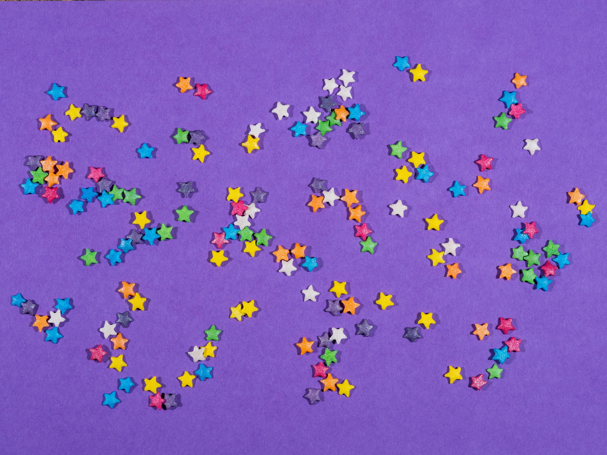 Colorful stars scattered across a purple background