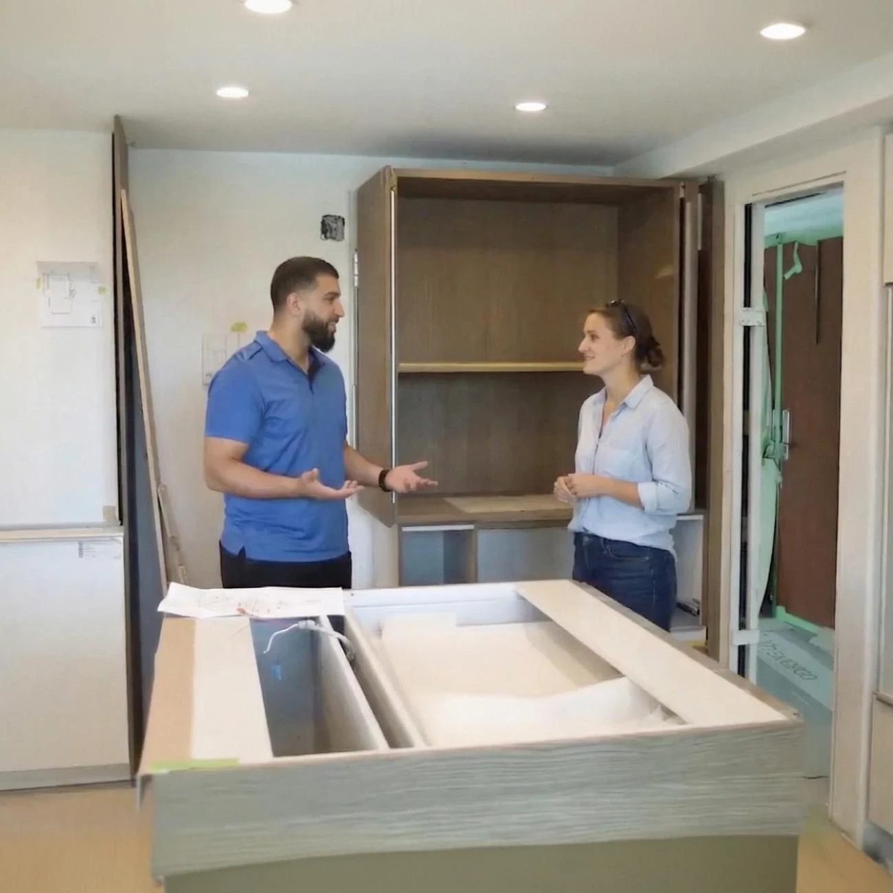 Custom home project manager reviewing construction progress with a homeowner inside a home under construction