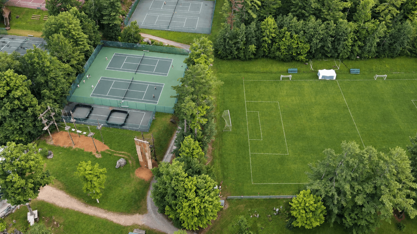 Aerial view of the private Camp Lenox property with courts and fields