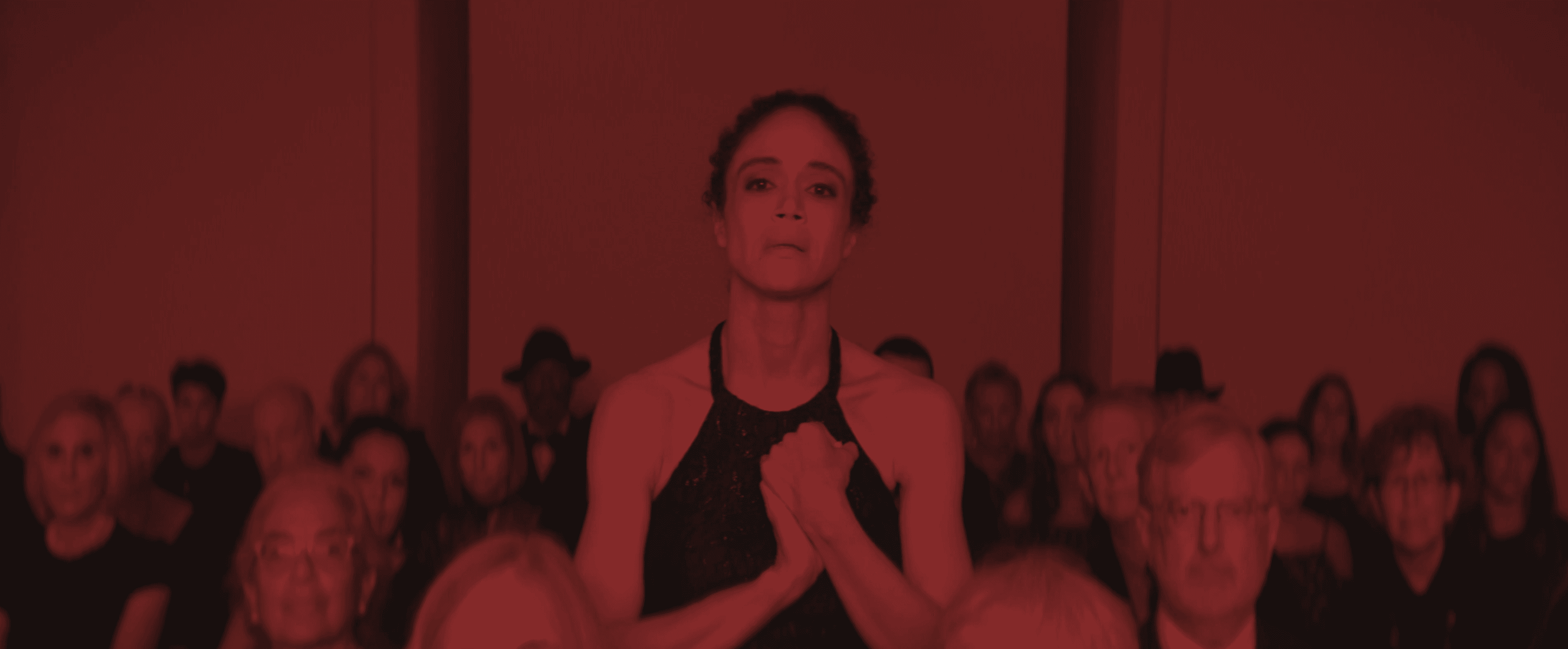 Two women reviewing fashion sketches and a large design document.