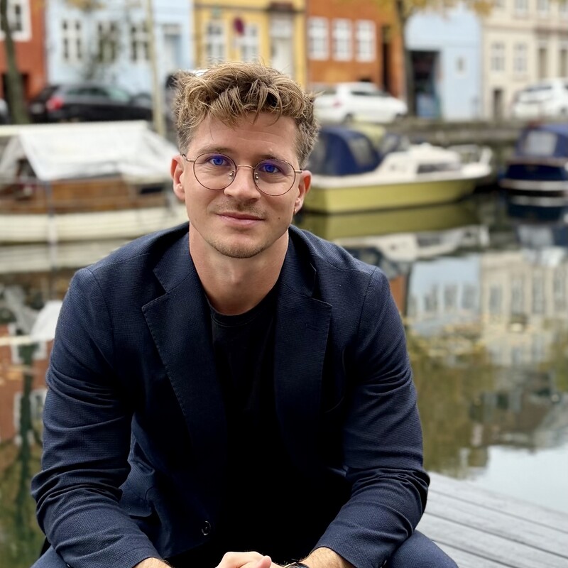 Man in suit sitting next to Capacit HQ