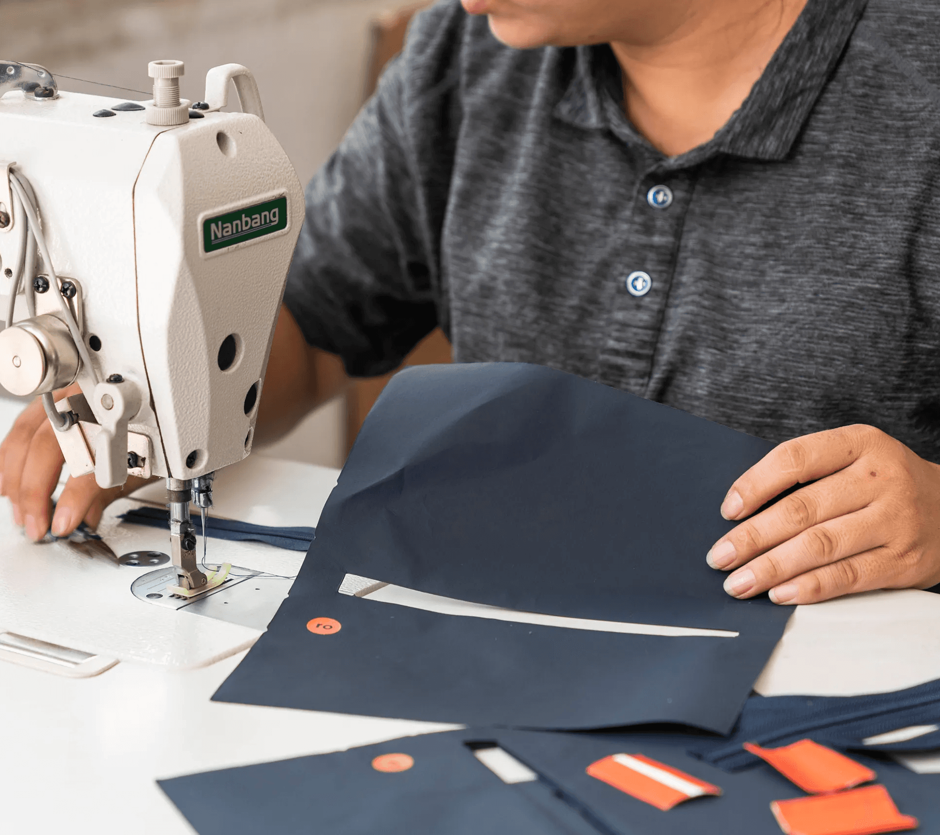 Production worker sewing and assembling Ro Health soft-goods product pouch