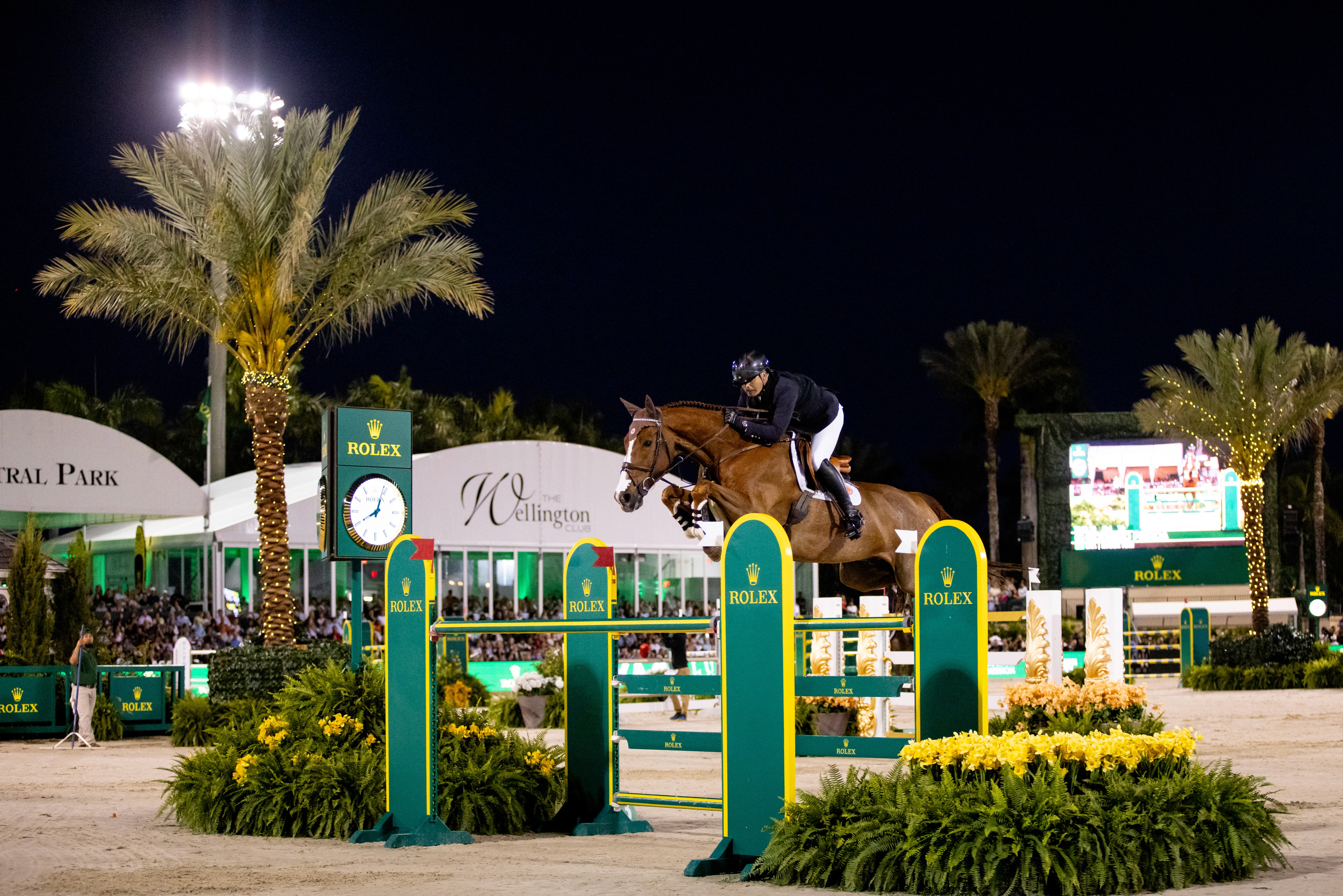A show jumping competition taking place at night at Wellington International in Florida