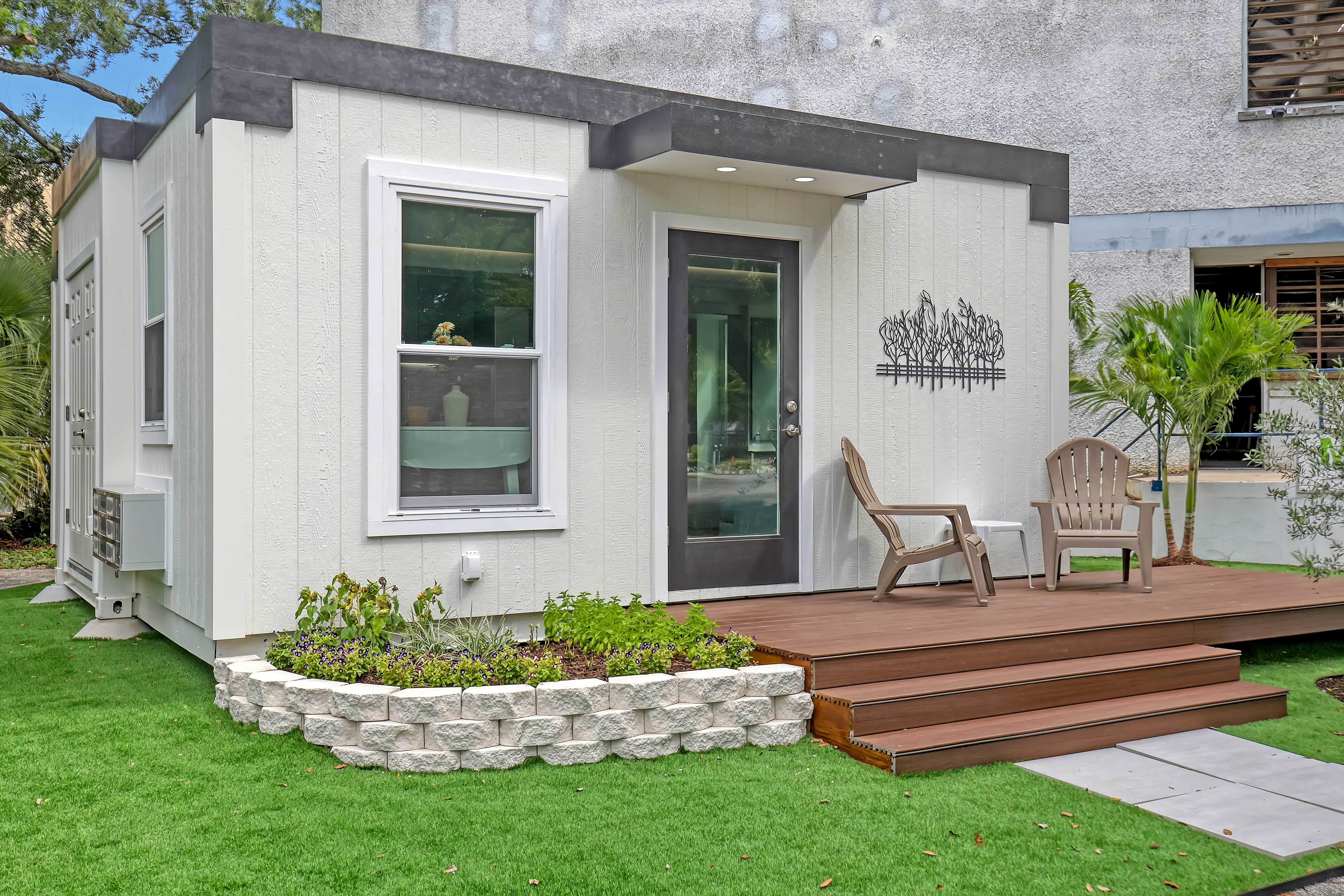 Mesocore Model E ADU exterior with wood deck and landscaped stone planter