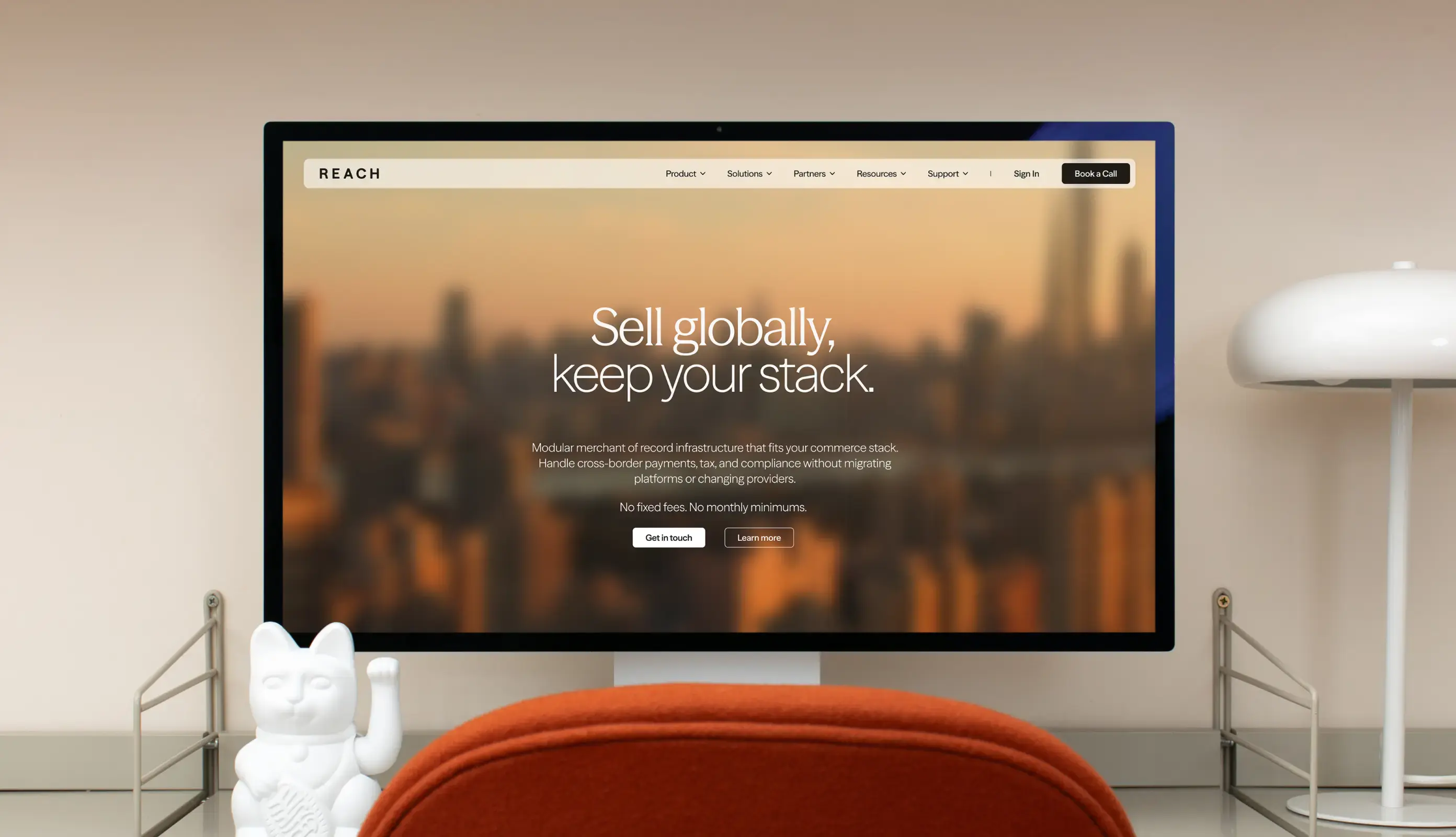 Reach homepage on a desktop monitor, featuring a warm cityscape and the headline “Sell globally, keep your stack."