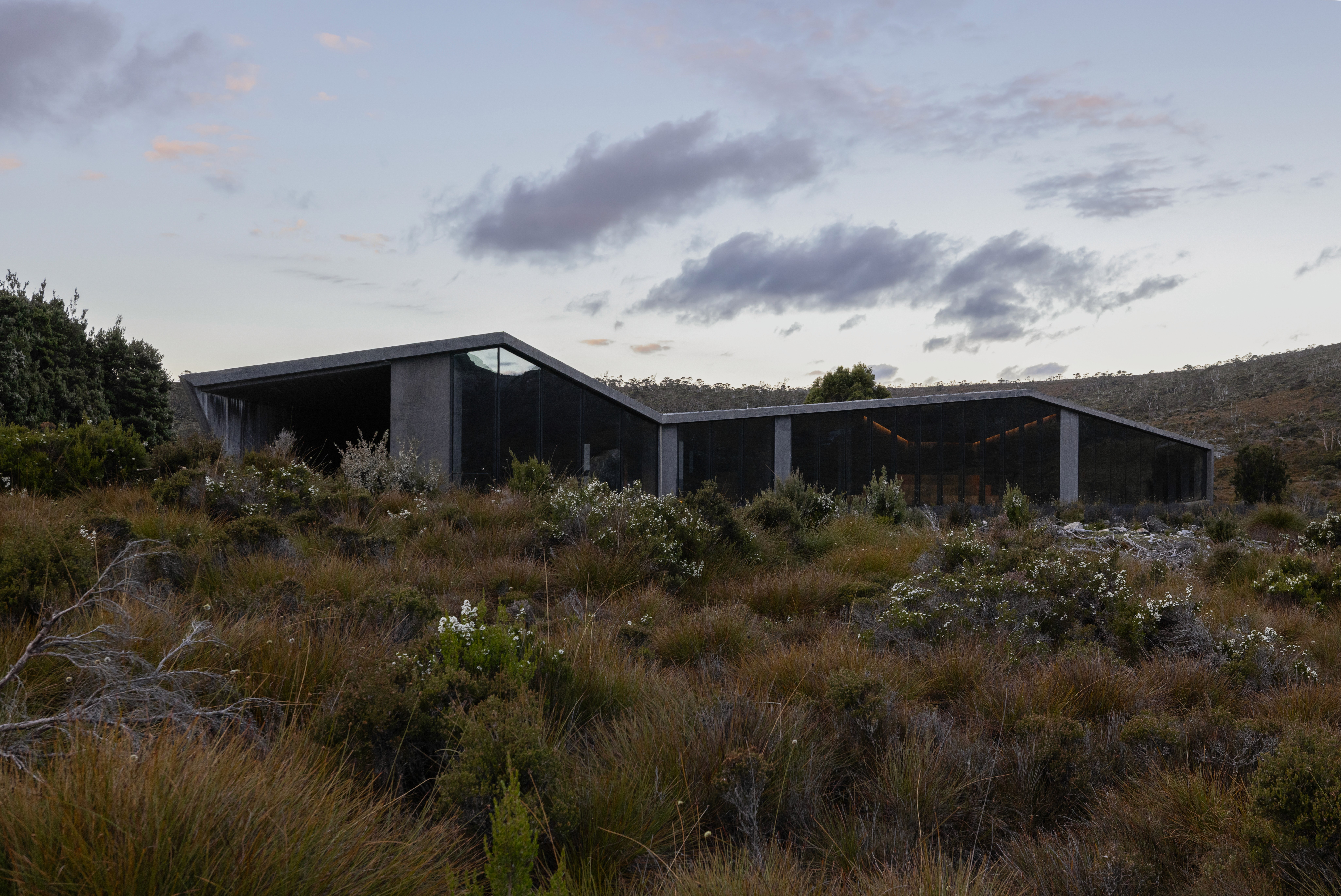 The power of a restrained palette. The muted, weathered tones of the concrete allow the structure to step back visually, ensuring the vibrant, shifting colors of the landscape remain the primary subject.