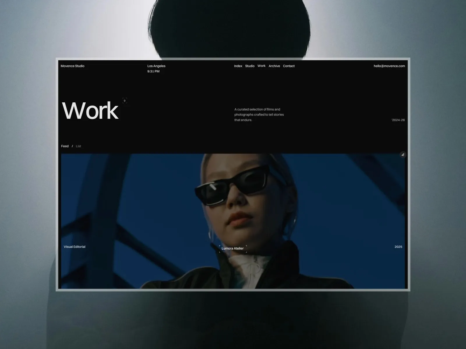 Dark-themed webpage featuring a person in sunglasses on a vibrant blue background.